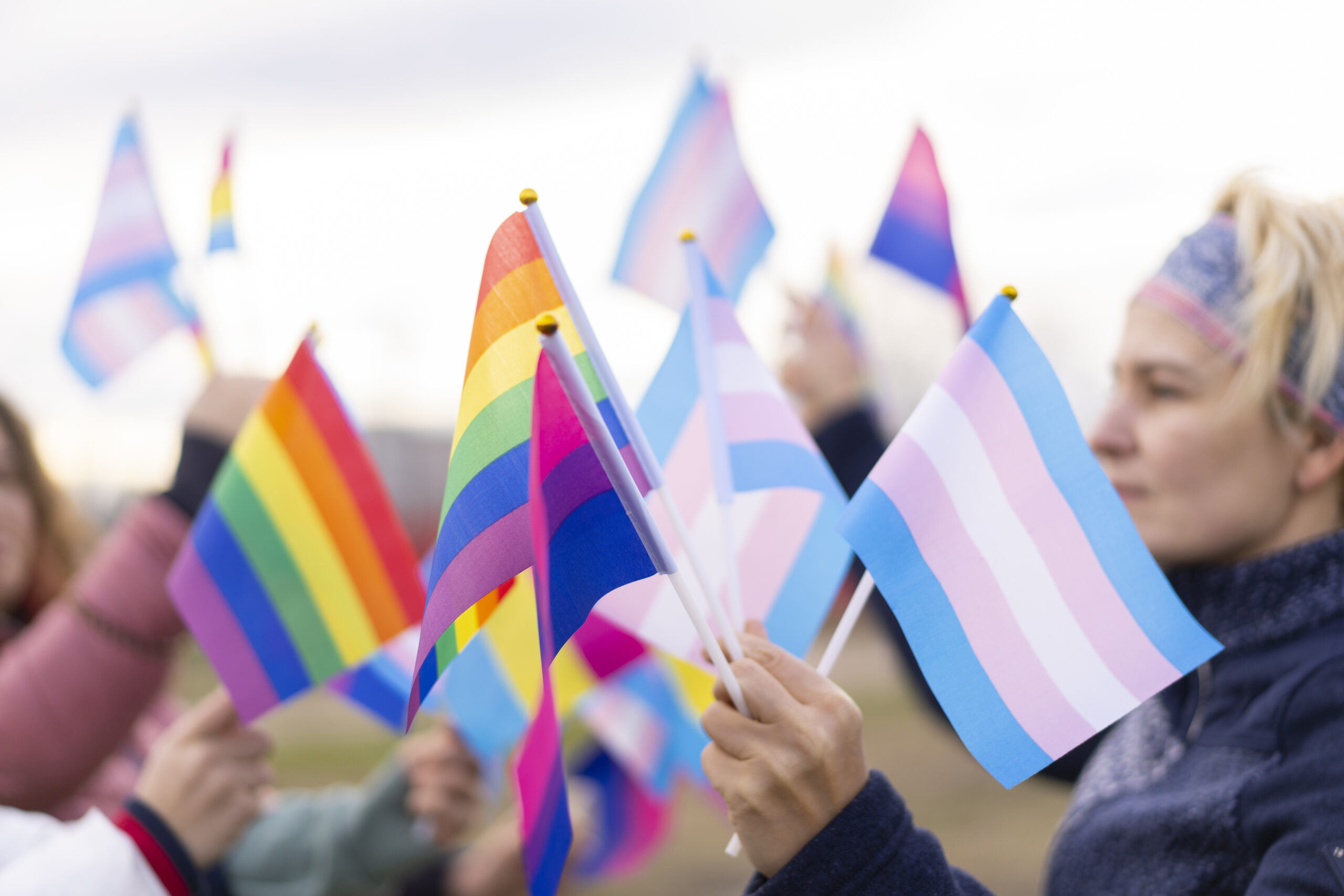 People holding flags in Protest defending the human rights for LGBTQ+ people