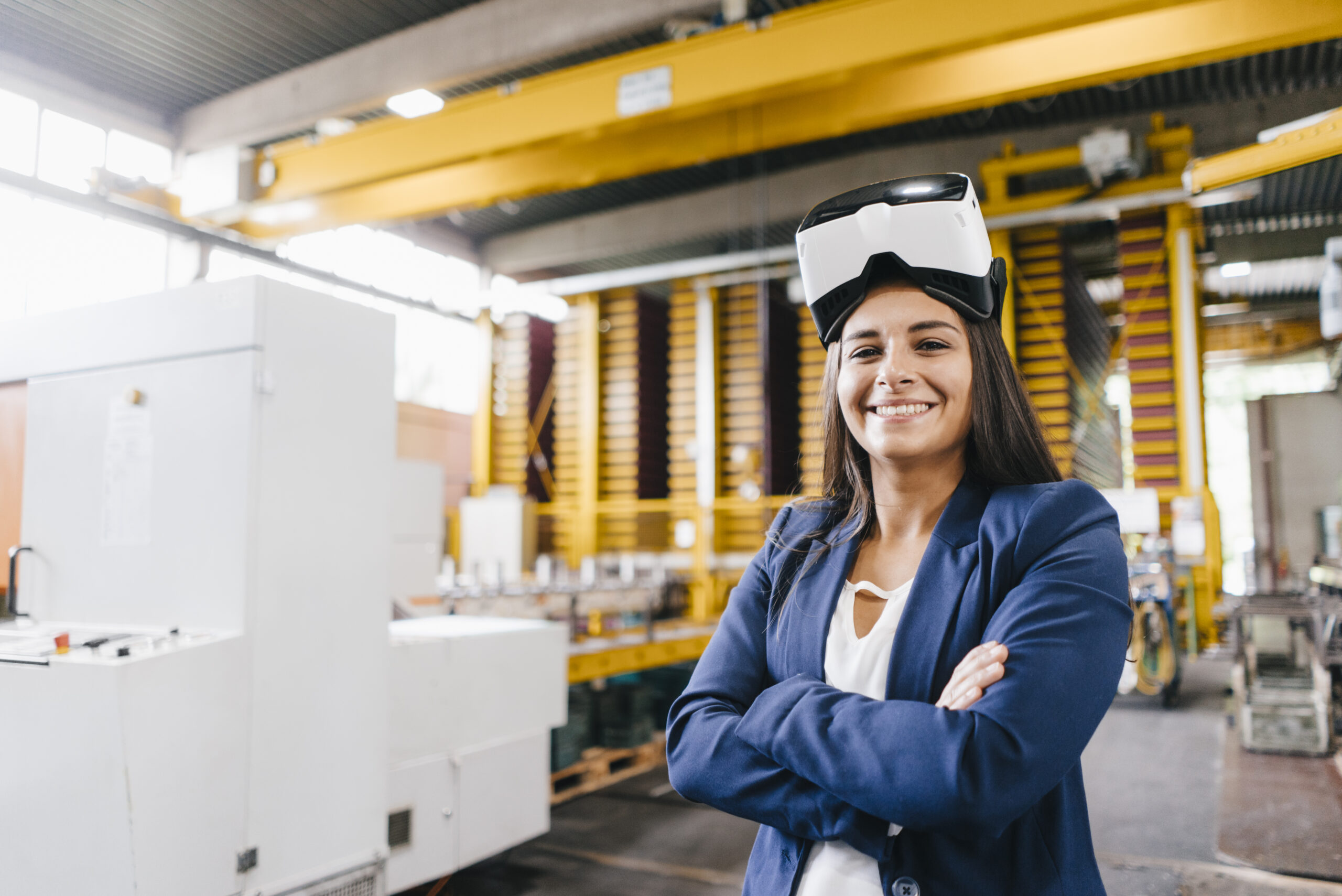 Young woman working in distribution warehouse, wearing VR glasses