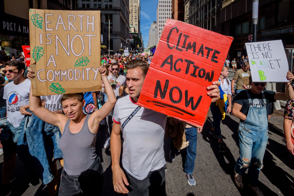 Photo of participants marching to Battery Park holding signs that say things related to climate change