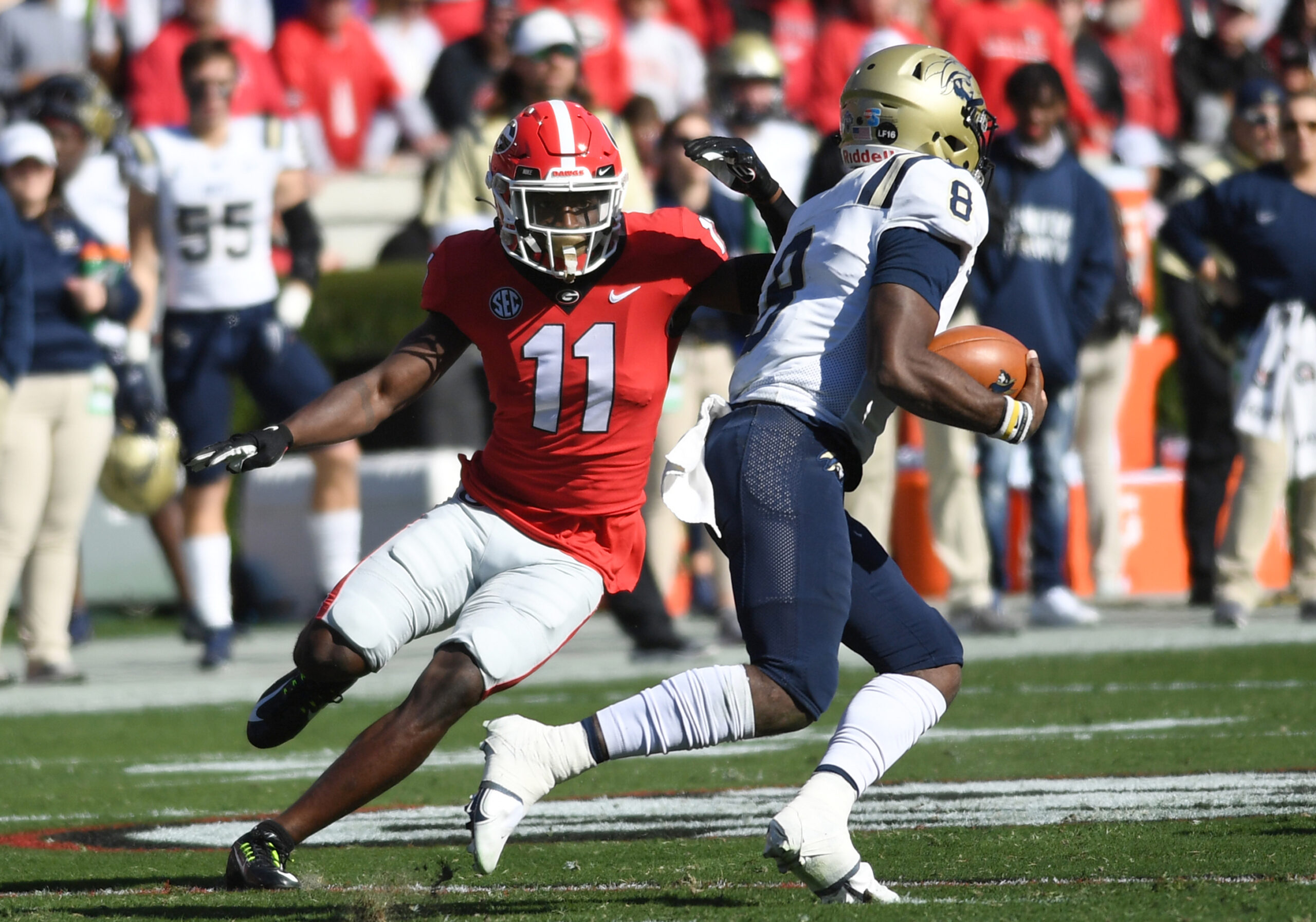 Georgia Bulldogs Defensive Back Derion Kendrick (11) pursues Charleston Southern Buccaneers Quarterback Jack Chambers (8) during the college football game between the Charleston Southern Buccaneers and the Georgia Bulldogs