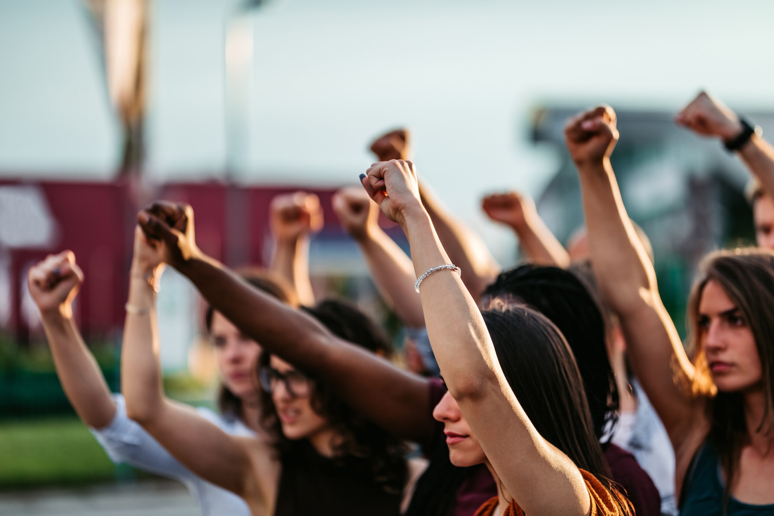 Protestors raising fists high above heads. Concept of protest, human rights, fighting.