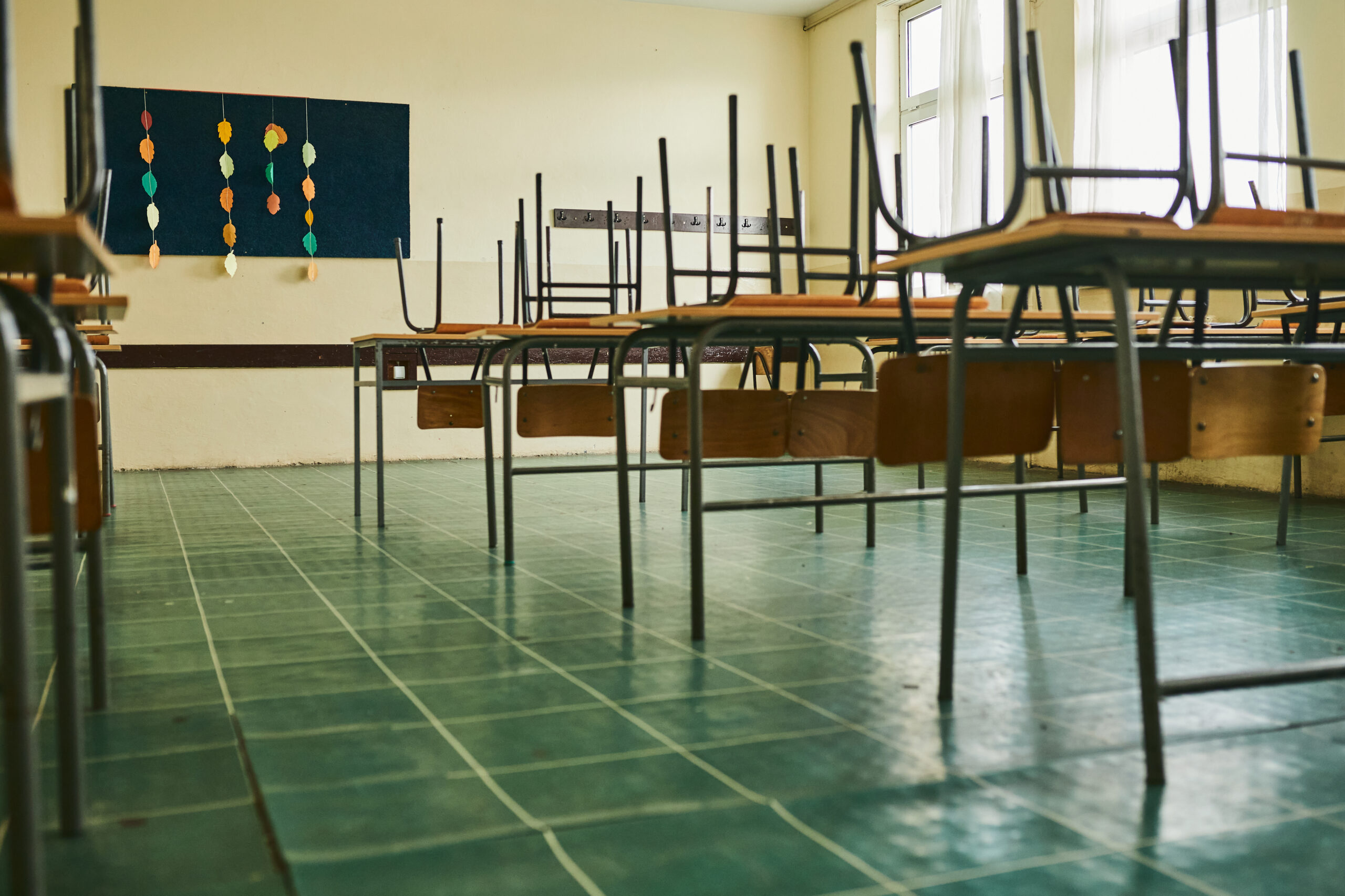 Empty classroom with chairs on the table during COVID-19 pandemic