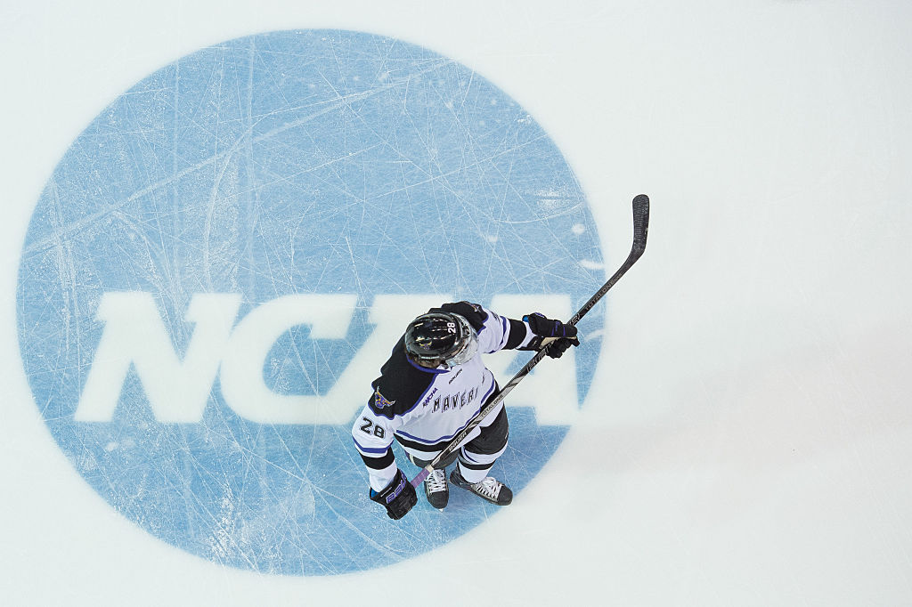 Minnesota State University Mavericks defenseman Jon Jutzi skates over the NCAA logo before the NCAA Midwest Regional hockey match.