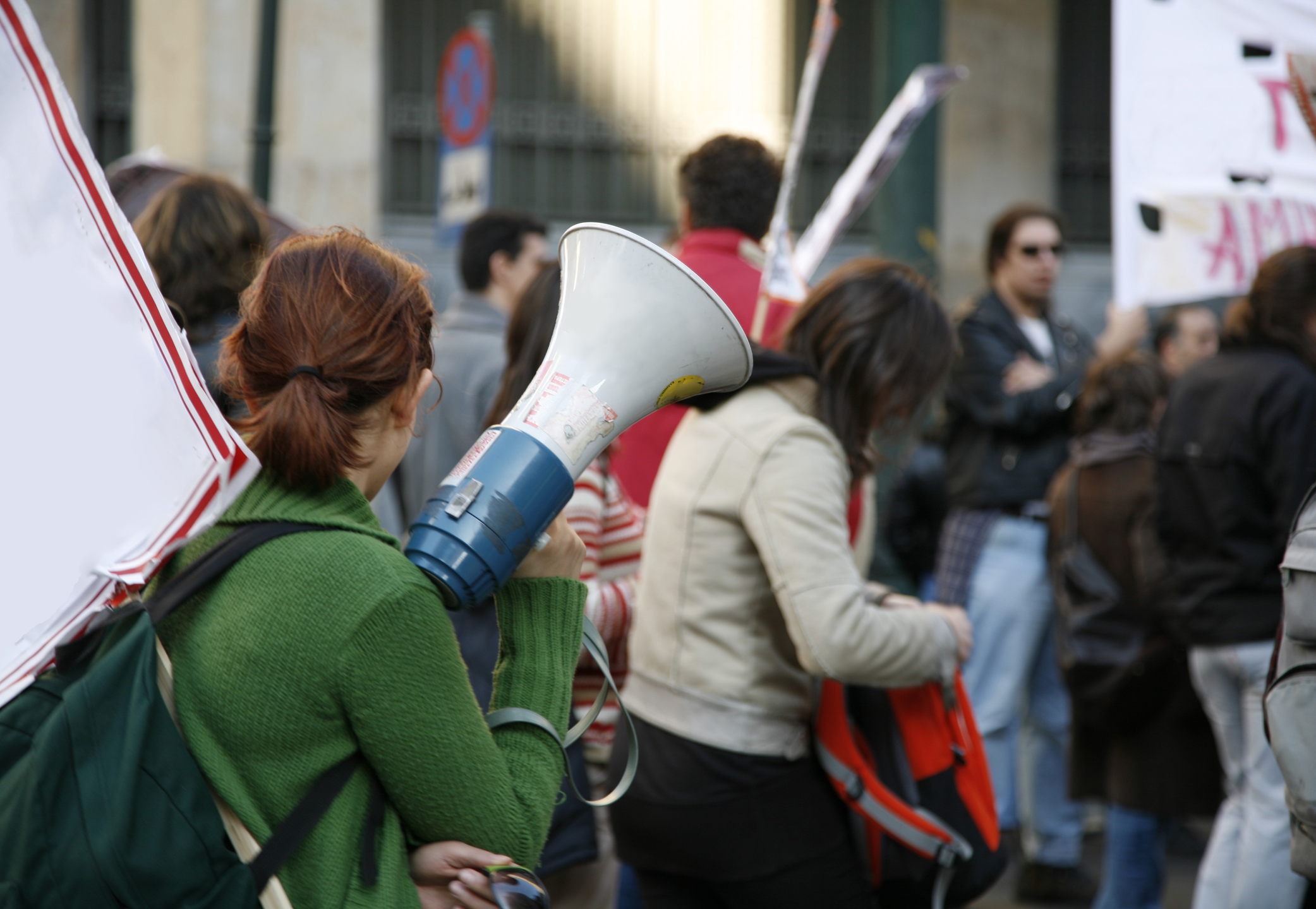 University students wave signs during a demonstration on campus.