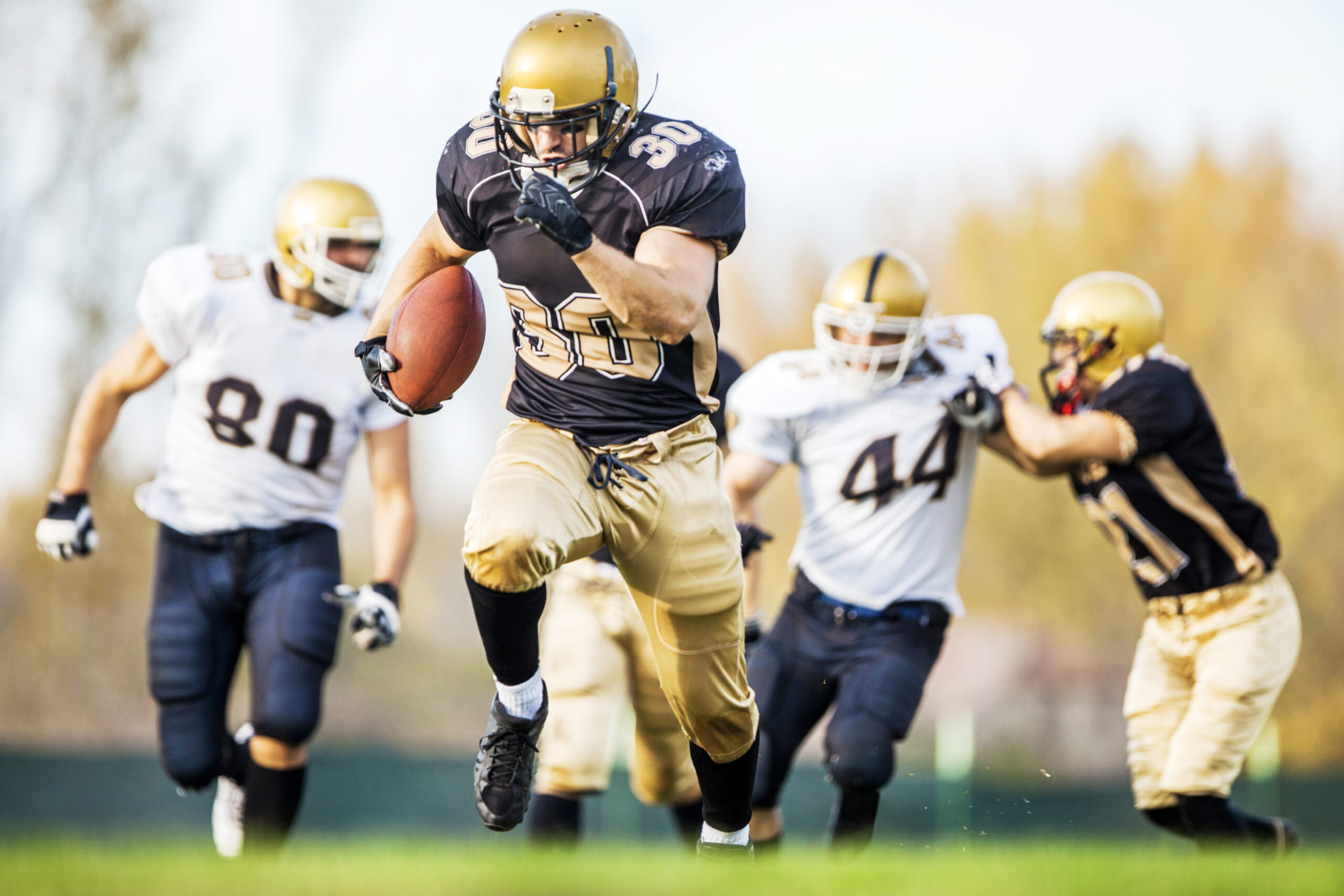 American football players in action on the playing field.