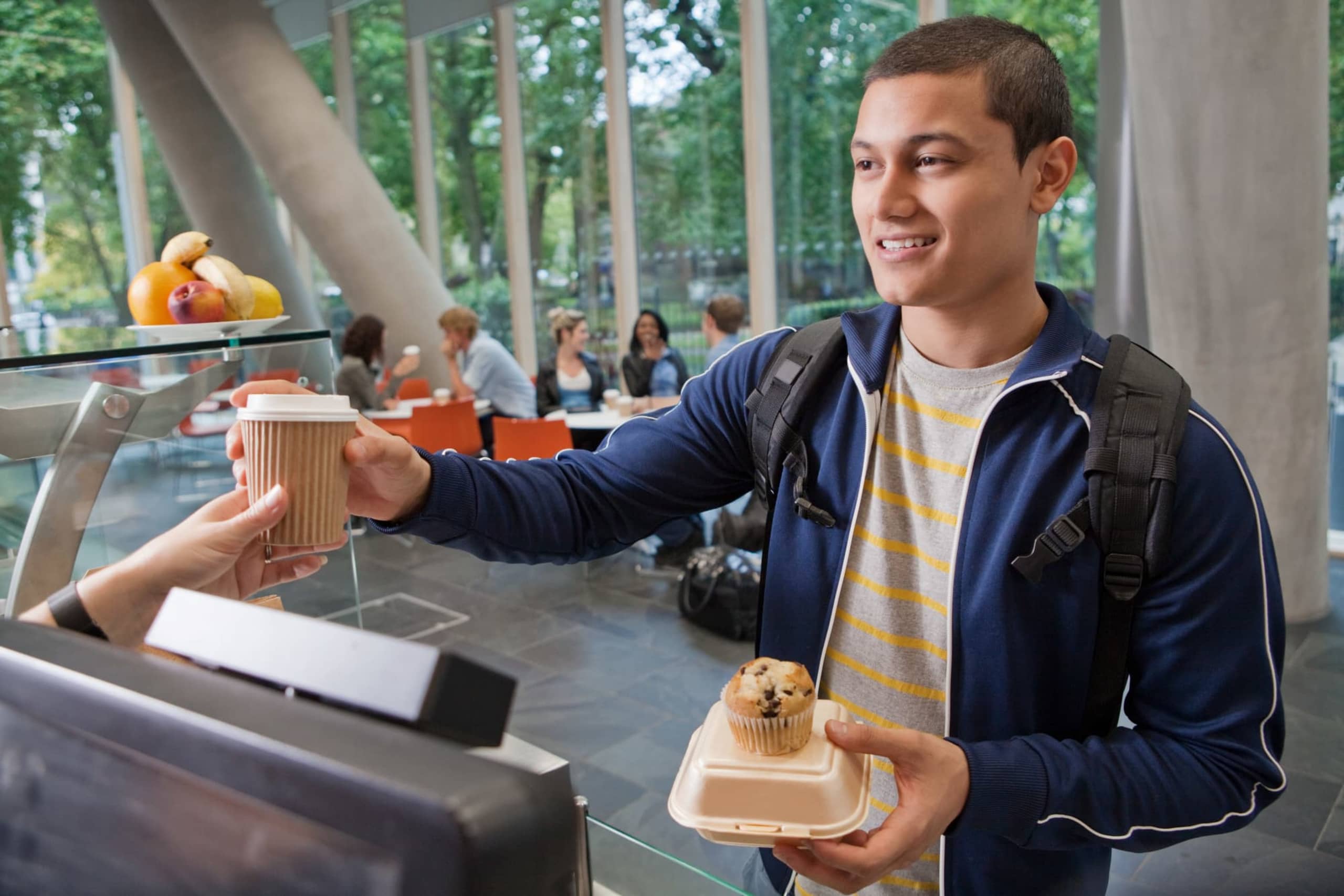 University student buying food in college cafe