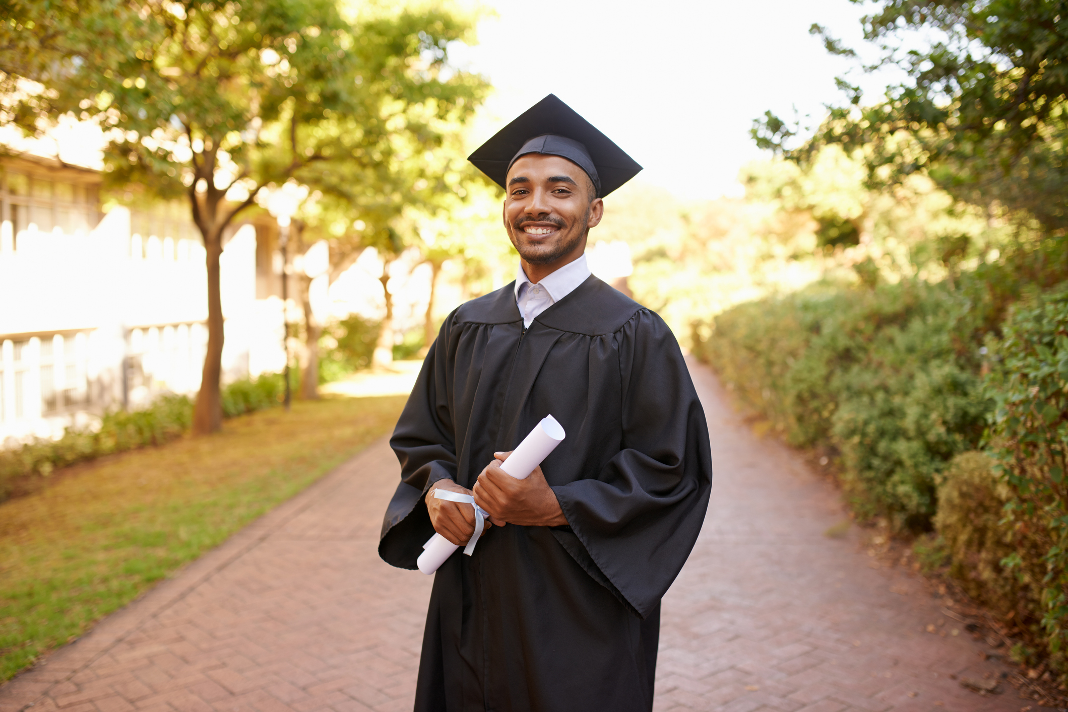 A new graduate holding a diploma.