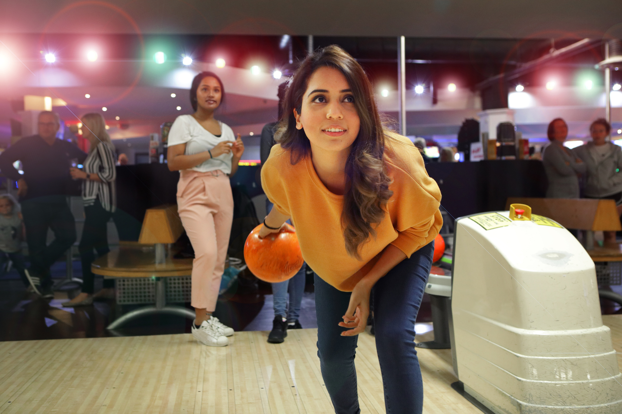 Group of young women bowling.