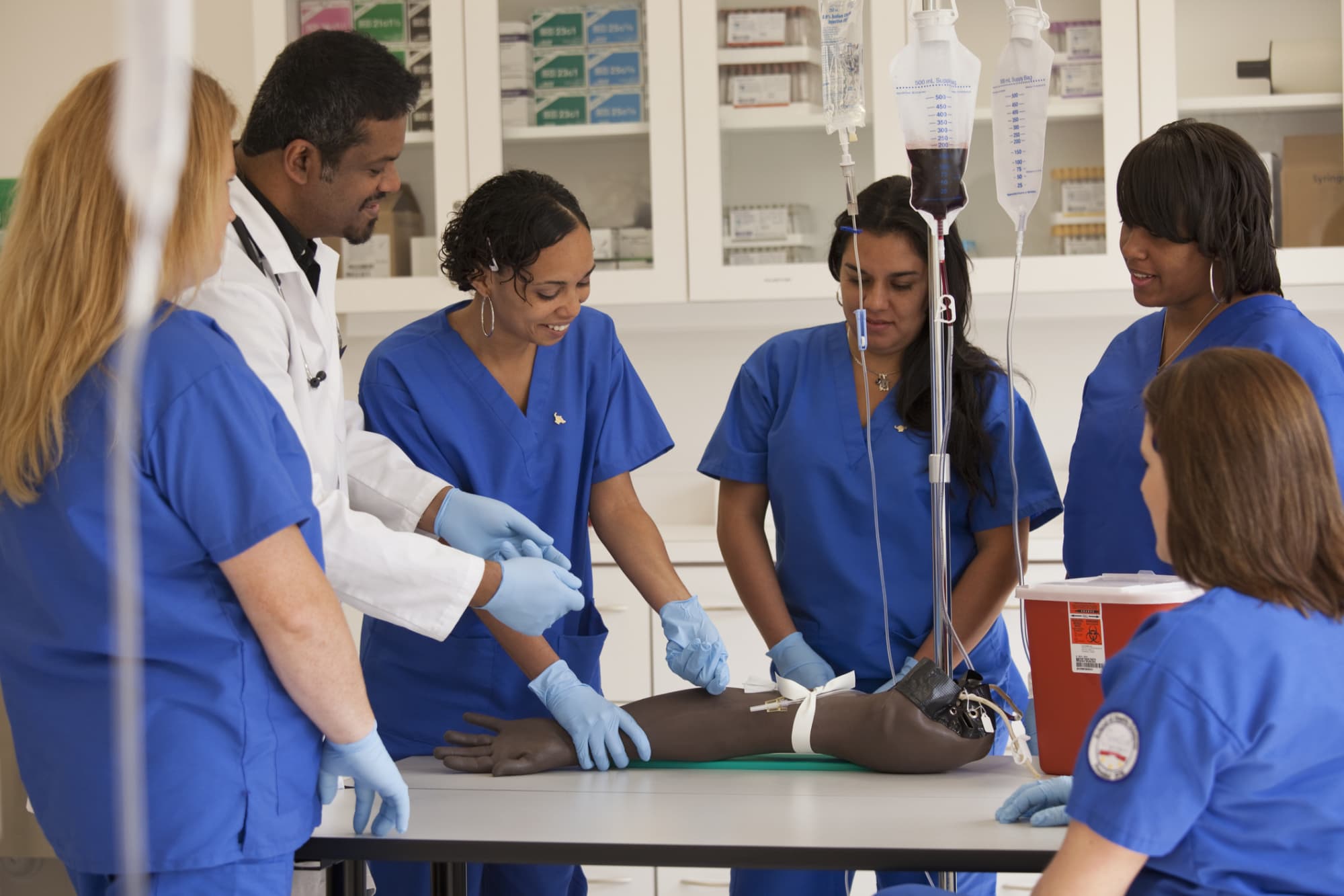 Nurses learning to insert an iv drip in hospital