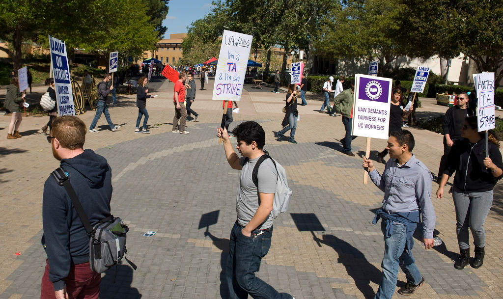 Teaching assistants, tutors and their supporters chant slogans and march during a union protest at the University of California, Irvine.