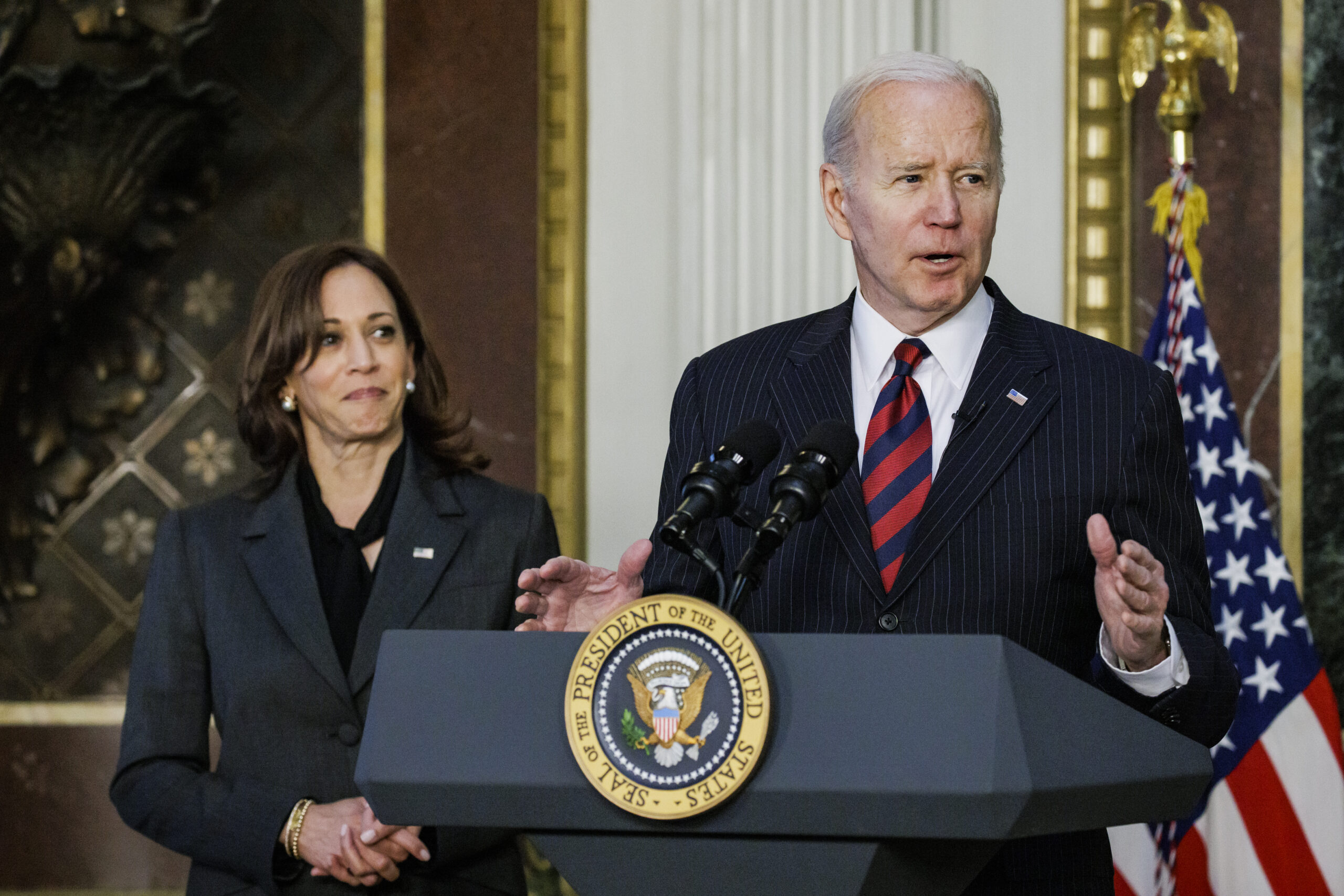 U.S. President Joe Biden speaks before signing H.R. 2471, the "Consolidated Appropriations Act, 2022," with U.S. Vice President Kamala Harris, left, in the Indian Treaty Room of the White House