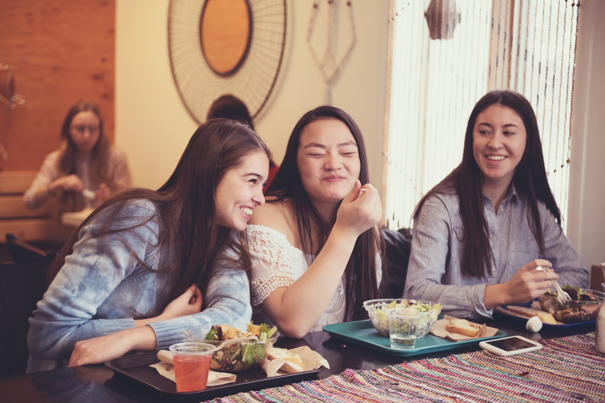 A group of female students eating in a college cafe.