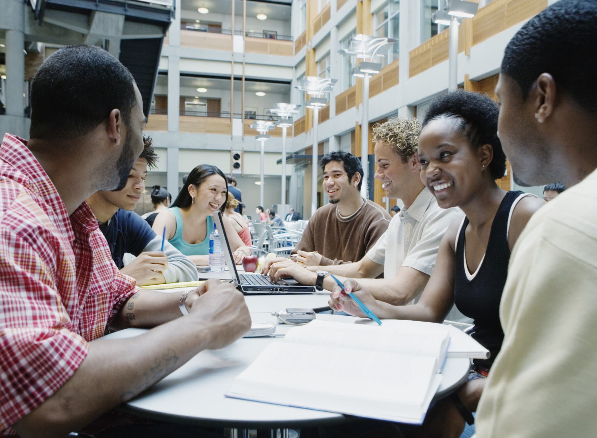 A group of college students study together in a campus building.