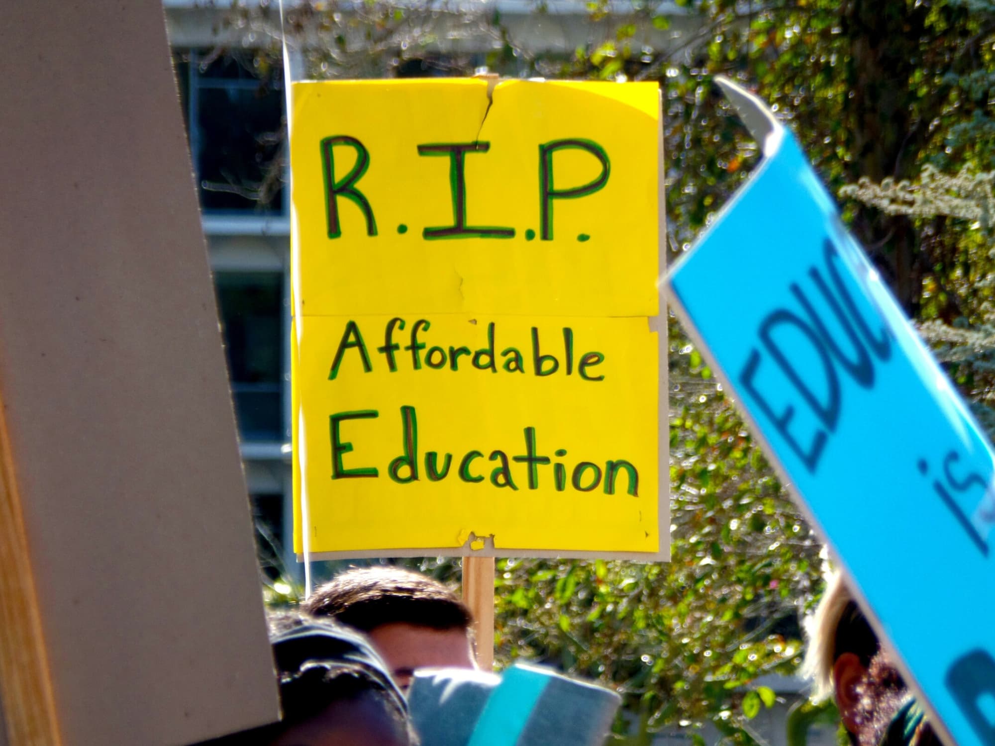 Students protest rising college costs on a college campus.