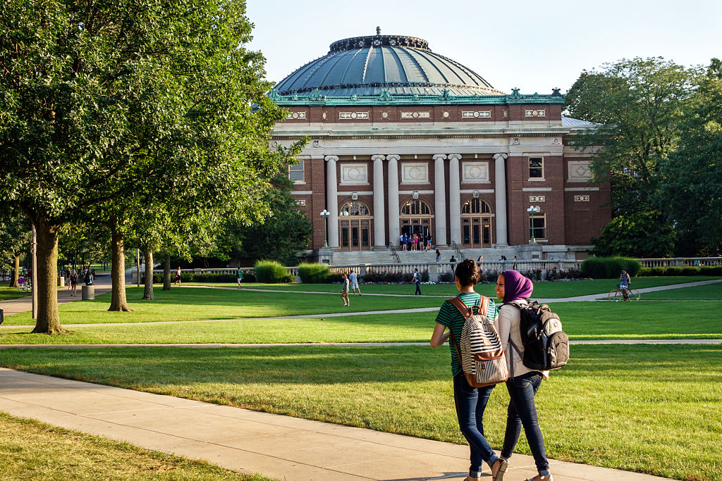 A pair of students walking on the University of Illinois campus.