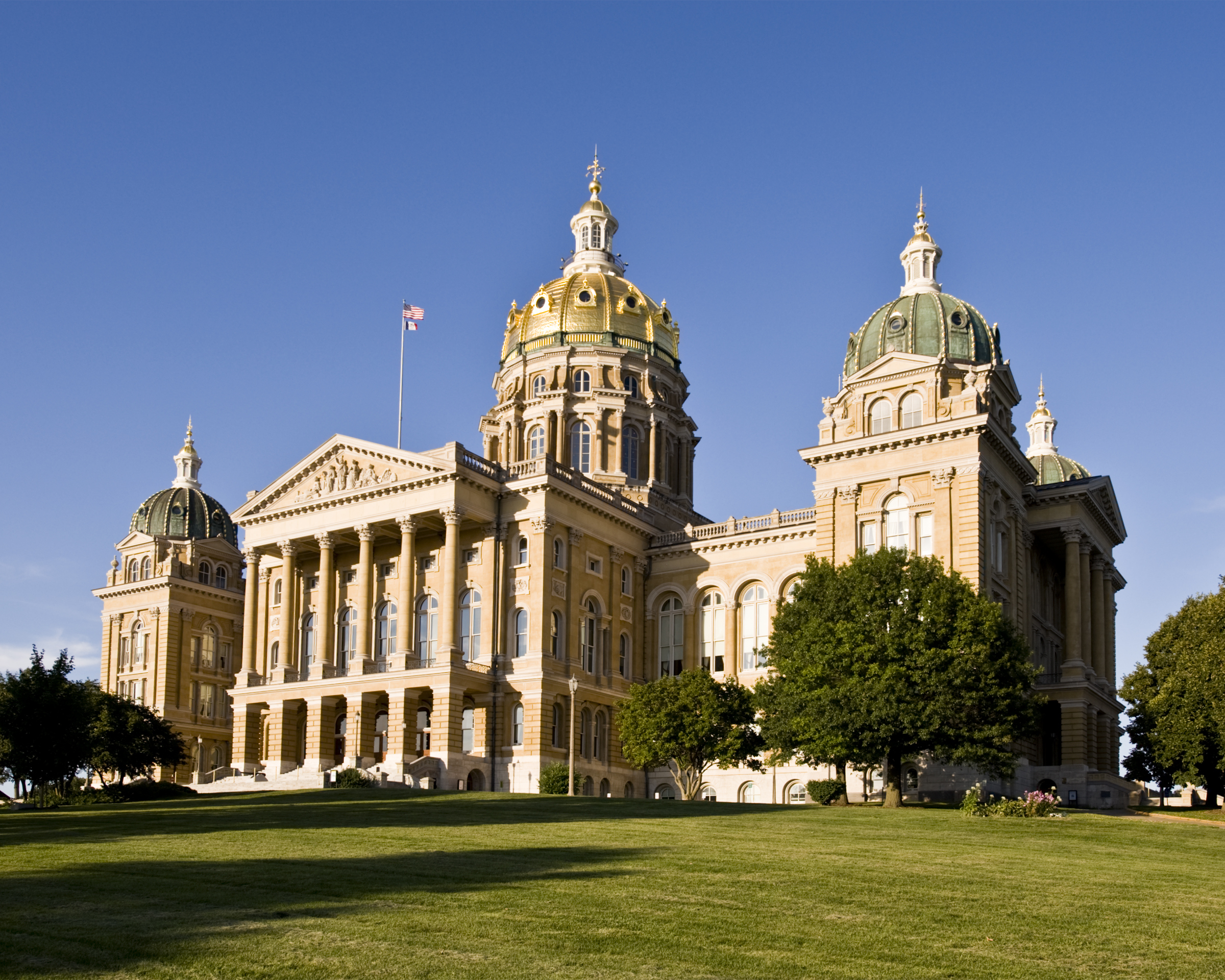 The gold leaf dome of the Iowa State Capitol glows in the evening sun.