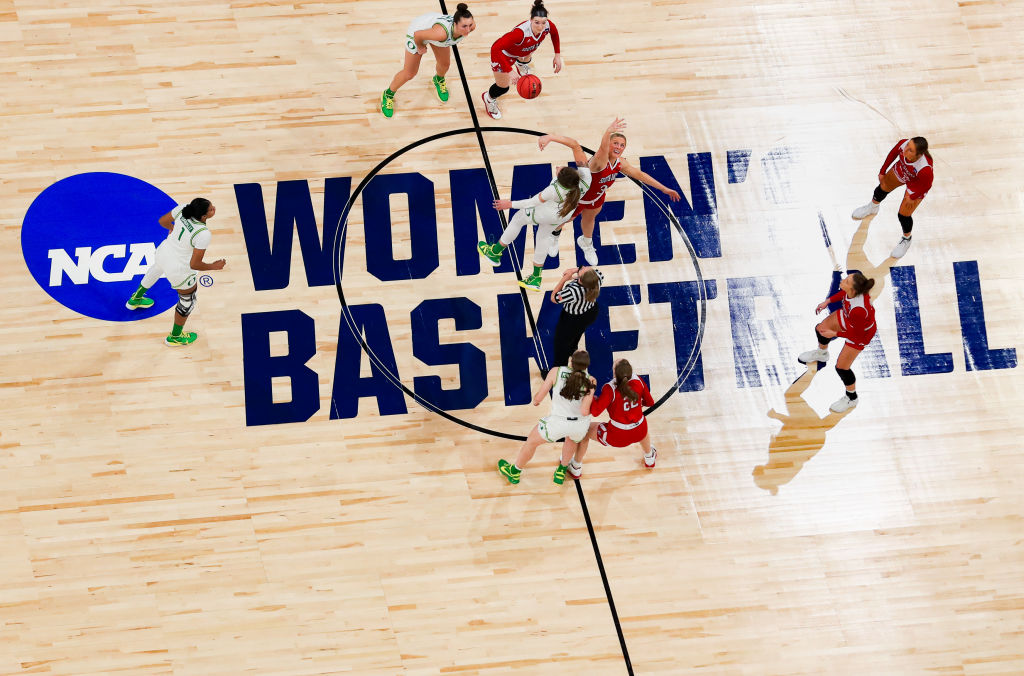 SAN ANTONIO, TEXAS - MARCH 22: Sedona Prince #32 of the Oregon Ducks and Macy Guebert #3 of the South Dakota Coyotes tip off in the first round game of the 2021 NCAA Women's Basketball Tournament at the Alamodome on March 22, 2021 in San Antonio, Texas.