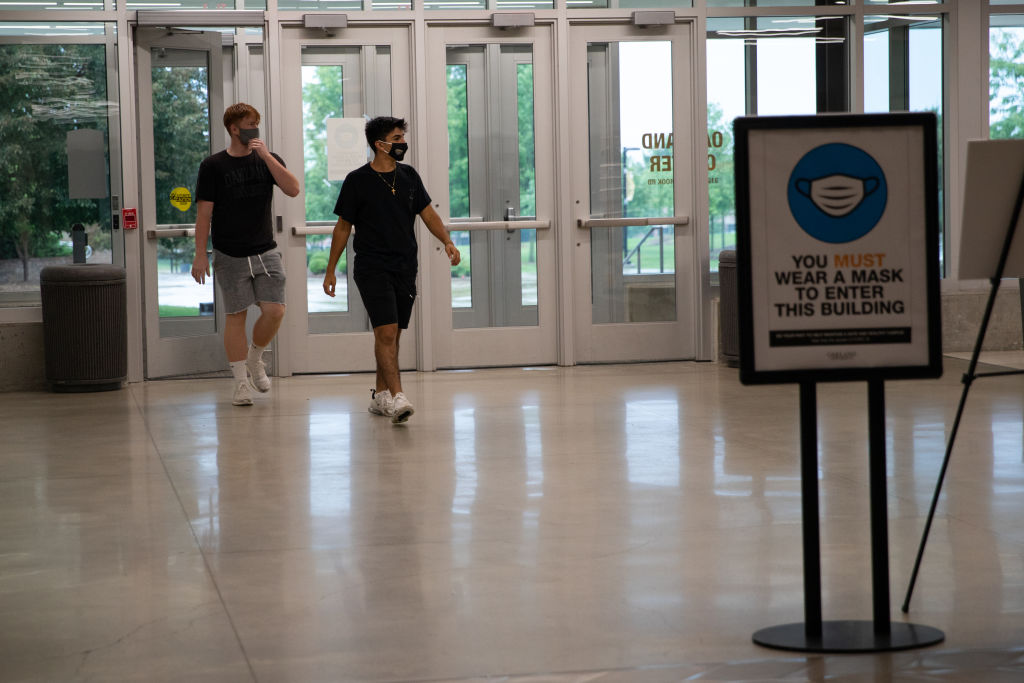 College students enter the student center during move-in day at Oakland University in Rochester, Michigan, U.S., on Friday, Aug. 27, 2021. Oakland University announced Monday that it will require all students, faculty and staff on campus to get a Covid-19 vaccine, expanding its previous policy that only required students living in dormitories to be vaccinated, according to The Detroit News.