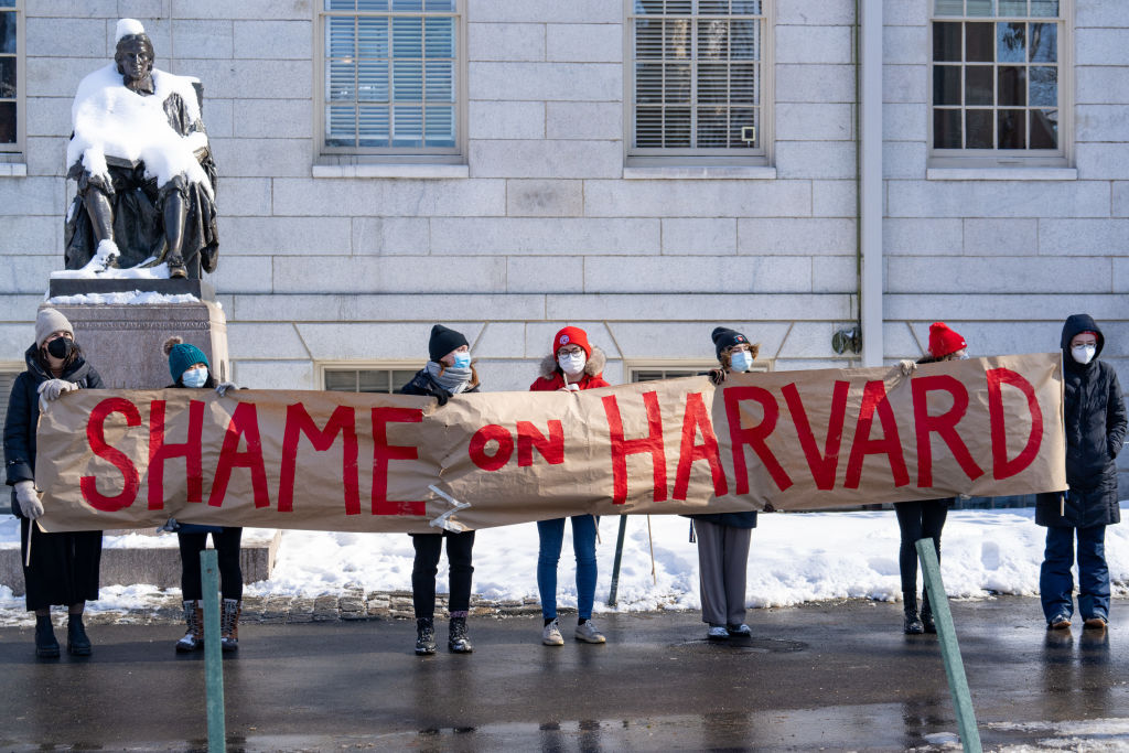 Demonstrators hold a banner during a 'No Justice Walkout' protest at Harvard University in Cambridge, Massachusetts, U.S., on Monday, Feb. 14, 2022. Harvard allowed a star professors sexual abuse of female students to continue unchecked for decades, contributing to a culture of harassment in its Anthropology Department, a new lawsuit alleges. Harvard University disputes the allegations of the lawsuit.