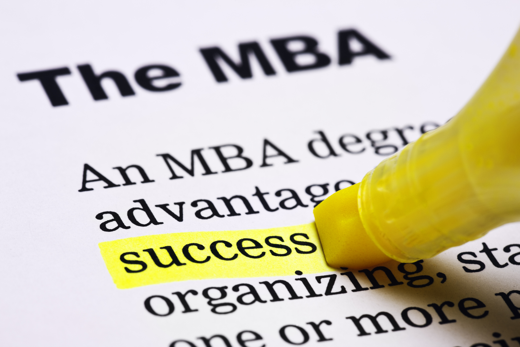 Under the heading 'The MBA' in a printed document, the word 'success' is highlighted in yellow.