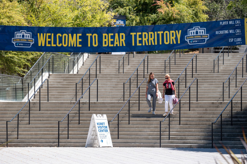 Students walk down the steps at the entrance to the California Memorial Stadium on the University of California campus in Berkeley, California.
