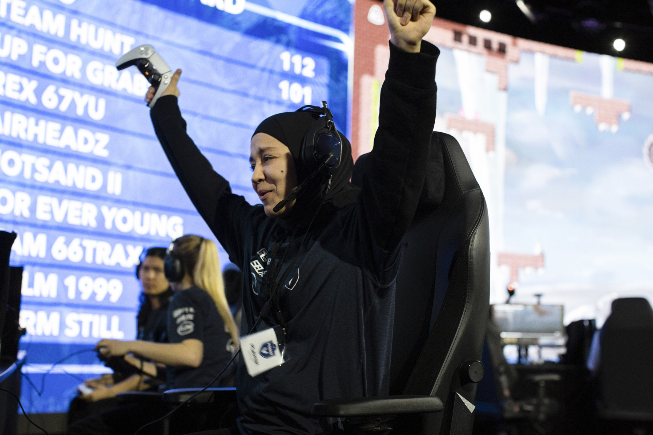 Cheerful female gamer won online video game while playing at eSports arena