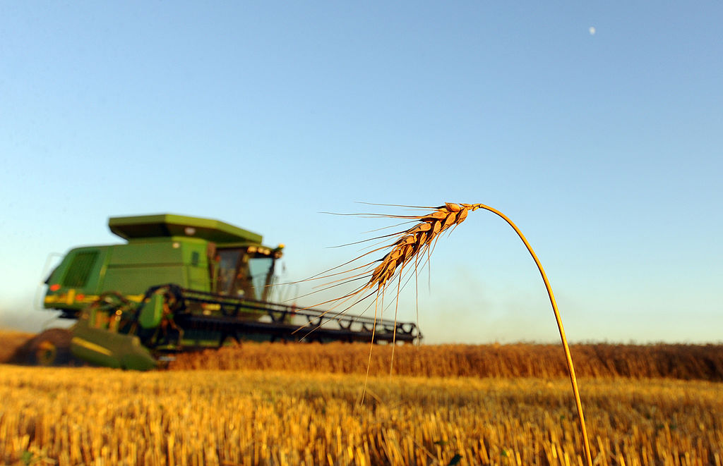 A John Deere combine harvests wheat near McPherson, Kansas, U.S., on Tuesday, June 30, 2009. Wheat prices lost 36 percent in the past year as global output reached a record 687 million metric tons in 2008-09, raising year-end stockpiles for the first time in four years. Photographer: Larry W. Smith/Bloomberg via Getty Images News