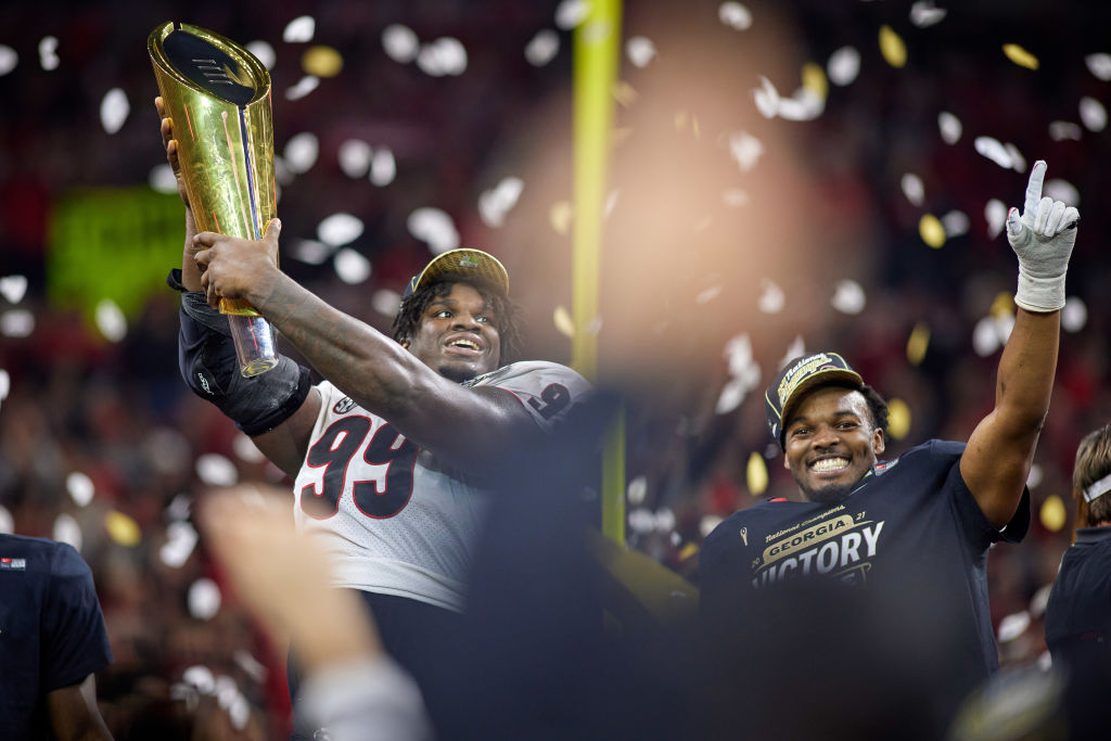 Georgia Bulldogs placekicker Jared Zirkel holds up and celebrates with the championship trophy after the College Football National Championship playoff game between the Alabama Crimson Tide and the Georgia Bulldogs on January 10, 2022.