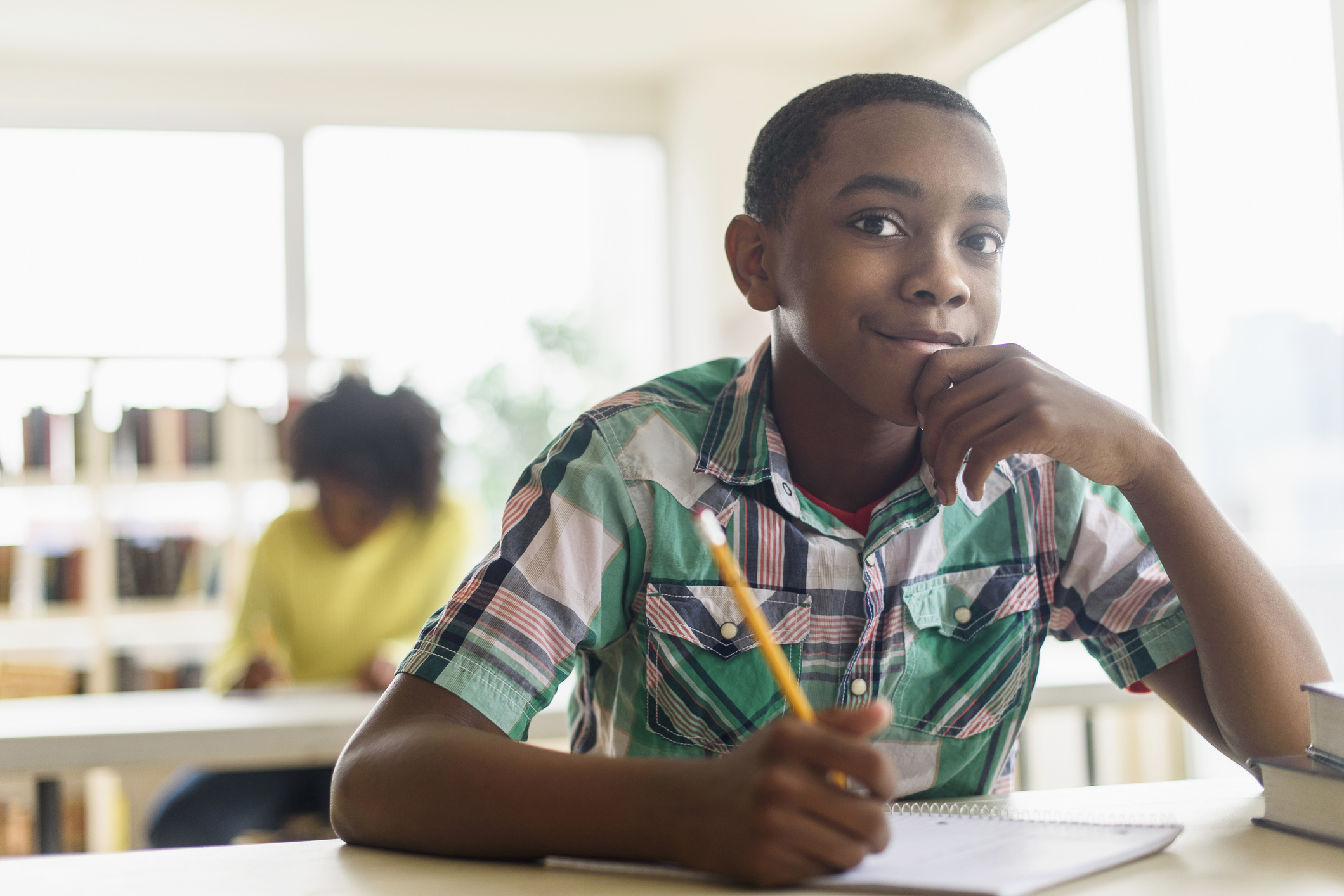 Black student thinking in classroom