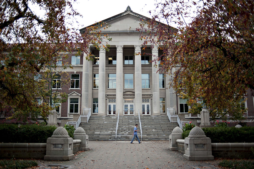 A student walks past the Hovde Hall of Administration building on the campus of Purdue University in West Lafayette, Indiana, U.S., on Monday, Oct. 22, 2012. Administrative costs on college campuses are soaring, crowding out instruction at a time of skyrocketing tuition and $1 trillion in outstanding student loans. At Purdue and other U.S. college campuses, bureaucratic growth is pitting professors against administrators and sparking complaints that tight budgets could be spent more efficiently. Photographer: Daniel Acker/Bloomberg via Getty Images