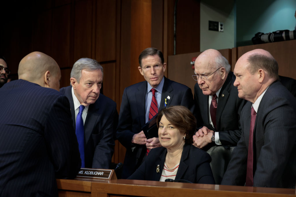 WASHINGTON, DC - APRIL 4: (L-R) Sen. Cory Booker (D-NJ), committee chairman Sen. Dick Durbin (D-IL), Sen. Richard Blumenthal (D-CT), Sen. Amy Klobuchar (D-MN), Sen. Patrick Leahy (D-VT) and Sen. Chris Coons (D-DE) speak with each other during a break in a Senate Judiciary Committee business meeting to vote on Supreme Court nominee Judge Ketanji Brown Jackson on Capitol Hill, April 4, 2022 in Washington, DC. A confirmation vote from the full Senate will come later this week. (Photo by Anna Moneymaker/Getty Images).