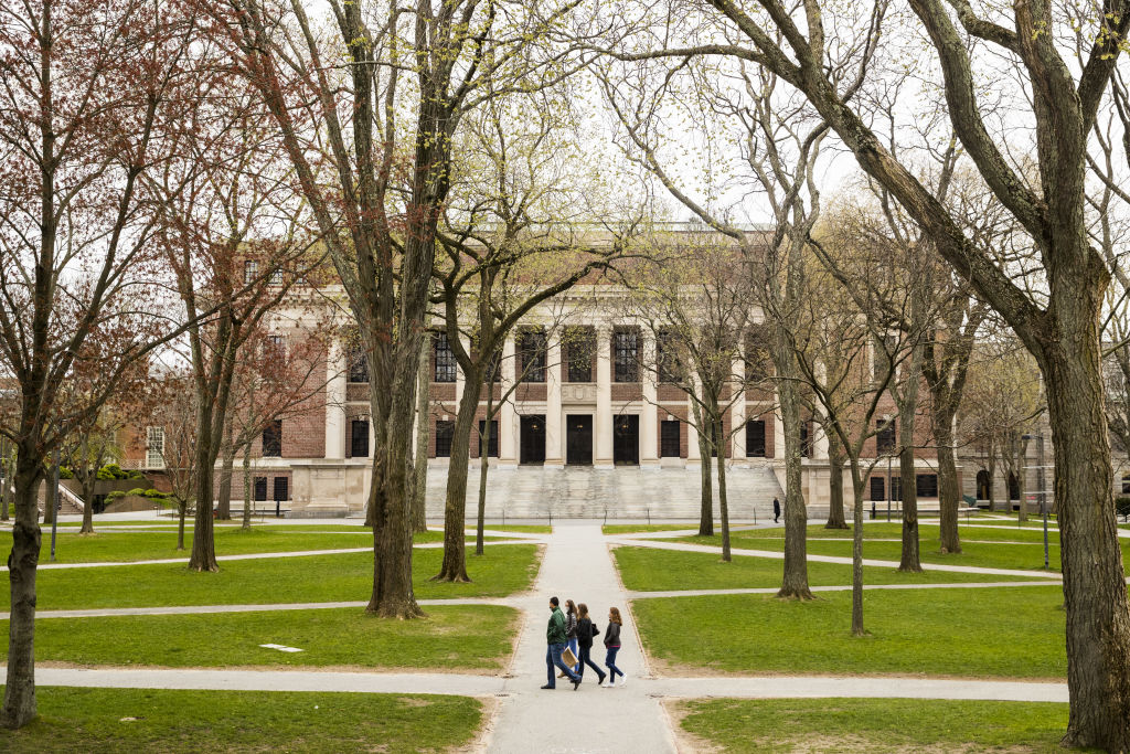 Pedestrians walk through Harvard Yard on the closed Harvard University campus in Cambridge, Massachusetts, U.S., on Monday, April 20, 2020. College financial aid offices are bracing for a spike in appeals from students finding that the aid packages they were offered for next year are no longer enough after the coronavirus pandemic cost their parents jobs or income. Photographer: Adam Glanzman/Bloomberg via Getty Images