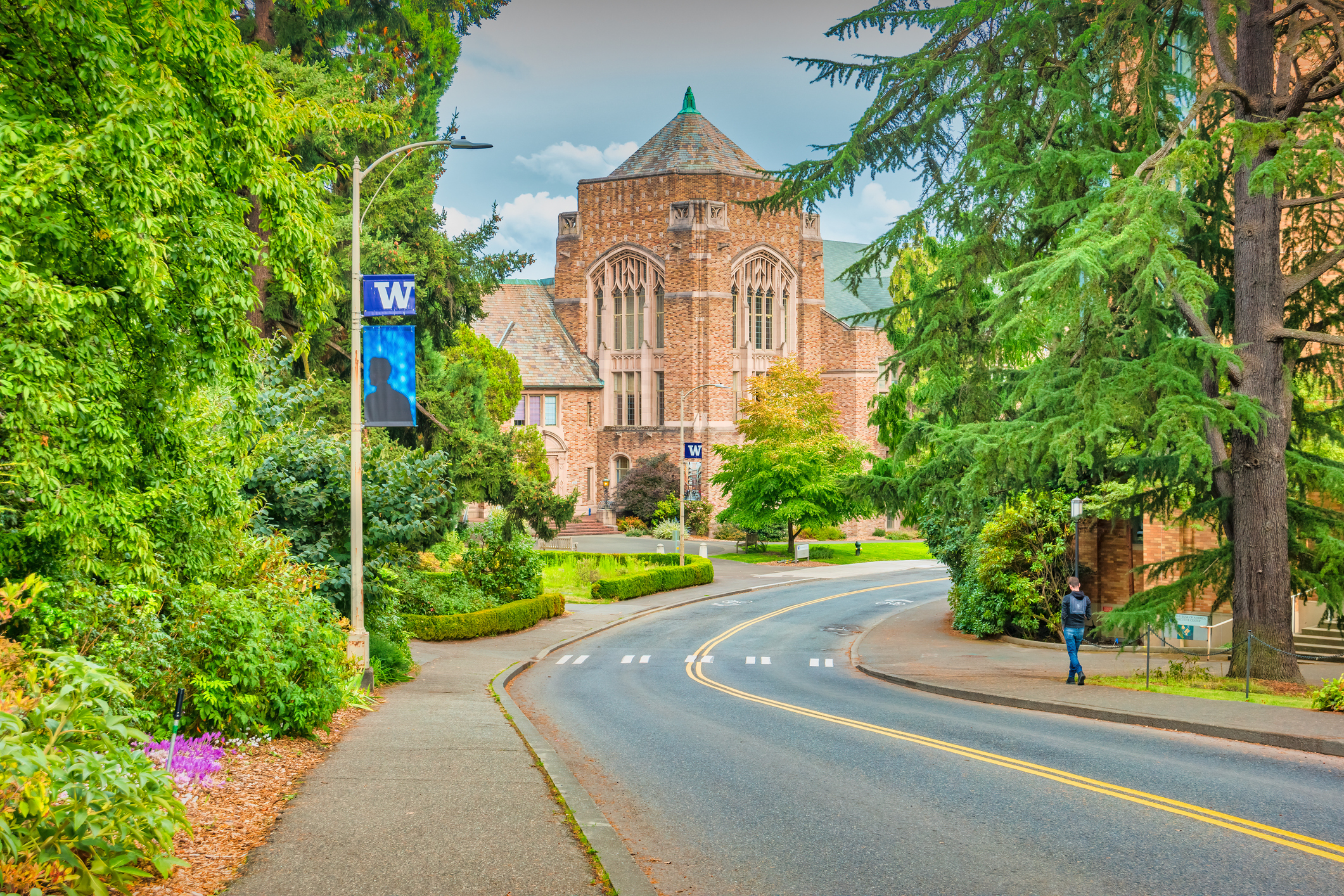 Student walks on the University of Washington campus in Seattle Washington USA on a cloudy day.