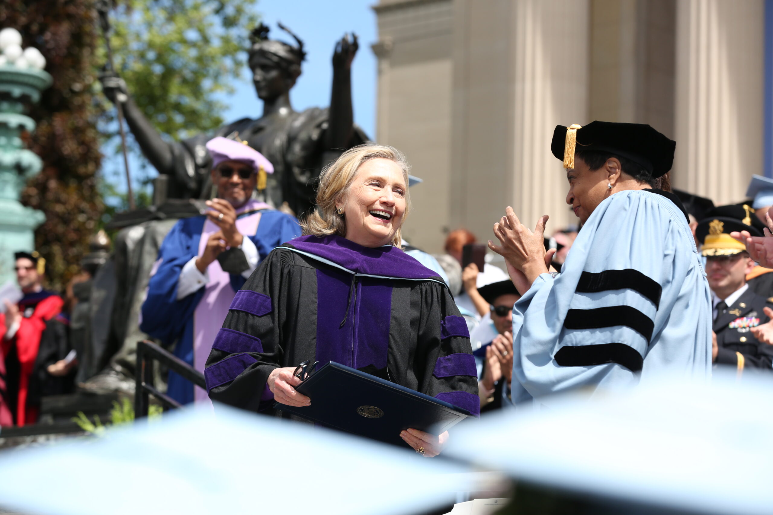 Photo of Hillary Clinton receiving accolades at Columbia University's Graduation commencement in May, 2022.