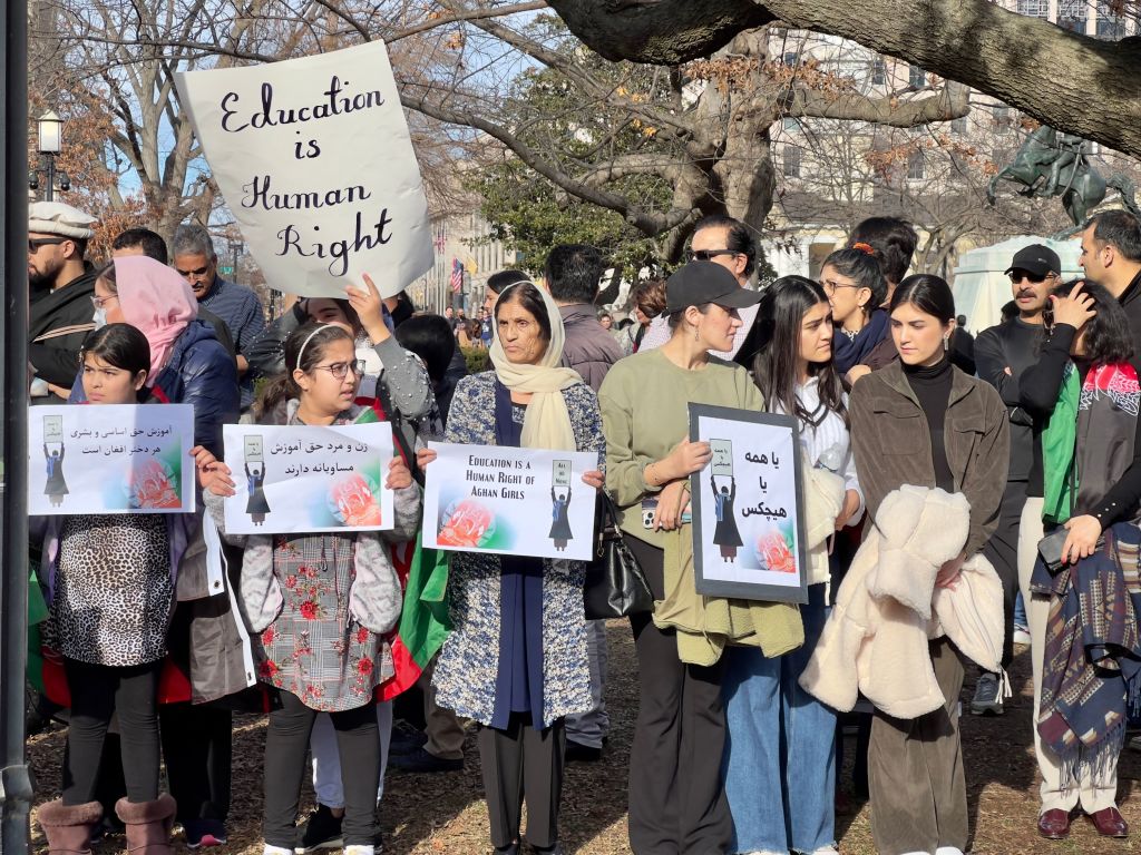 People demonstrate in front of the White House in Washington, DC, on January 1, 2023 against the Afghan Taliban regime's ban of higher education for womwn. - The UN Security Council on December 27, 2022 called on the Taliban to reverse policies targeting women and girls in Afghanistan, expressing alarm at the "increasing erosion" of human rights in the country. (Photo by Daniel SLIM / AFP) (Photo by DANIEL SLIM/AFP via Getty Images)