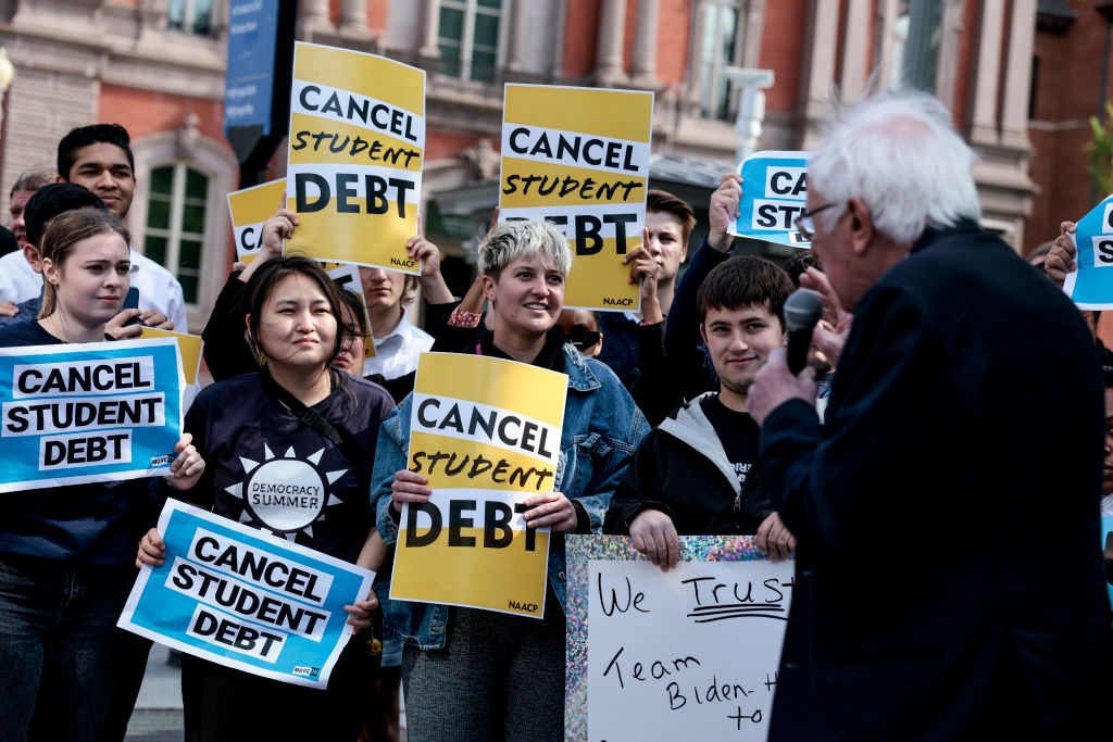 WASHINGTON, DC - APRIL 27: Activists listen as Sen. Bernie Sanders (I-VT) speaks at a Student Loan Forgiveness rally on Pennsylvania Avenue and 17th street near the White House on April 27, 2022 in Washington, DC. Student loan activists including college students held the rally to celebrate U.S. President Joe Biden's extension of the pause on student loans and also urge him to sign an executive order that would fully cancel all student debt. (Photo by Anna Moneymaker/Getty Images)