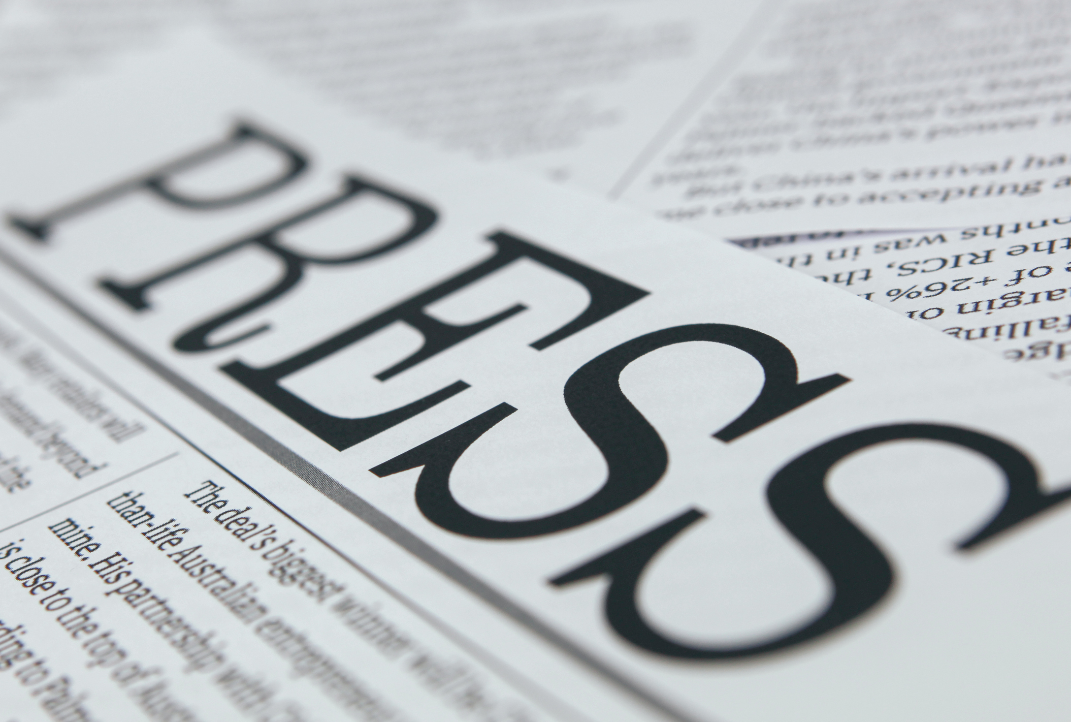 A close up picture of the word "Press" written atop a newspaper page.