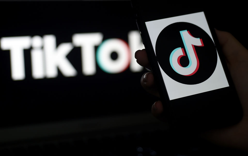 In this photo illustration, the social media application logo, TikTok is displayed on the screen of an iPhone on April 13, 2020, in Arlington, Virginia - TikTok has pledged $250 million to local organizations around the world supporting healthcare, education, and struggling communities impacted by the coronavirus pandemic. (Photo by Olivier DOULIERY / AFP) (Photo by OLIVIER DOULIERY/AFP via Getty Images)