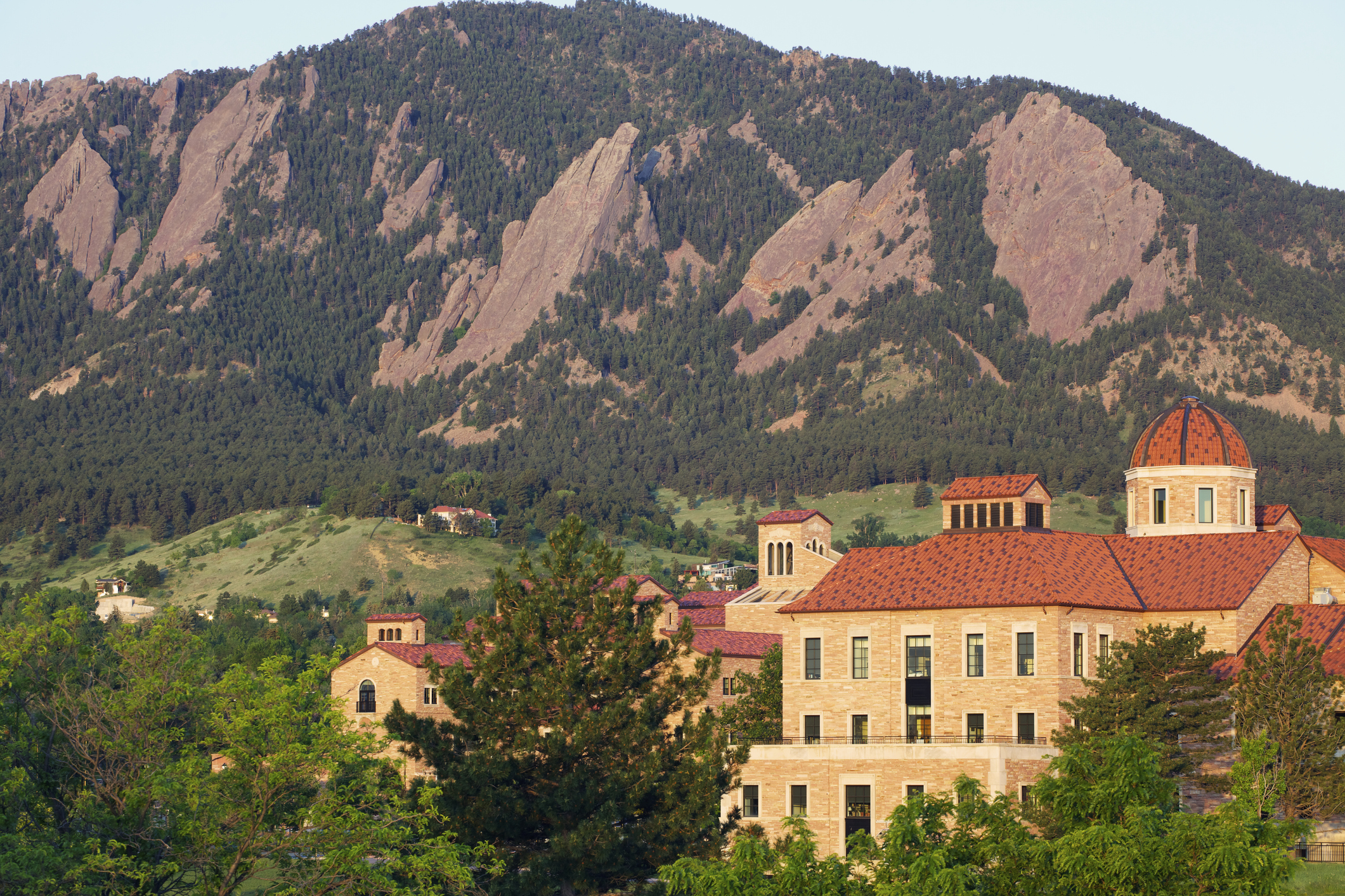 The flatirons behind a classroom building on the University of Colorado campus in Boulder Colorado.