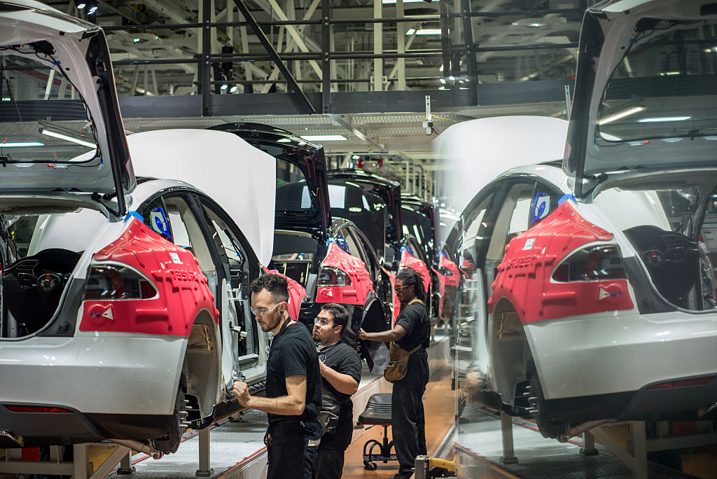 Workers assemble cars on the line at Tesla's factory in Fremont, California.