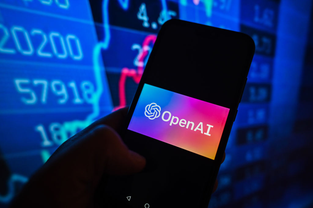 POLAND - 2023/03/21: In this photo illustration, an Open AI logo is displayed on a smartphone with stock market percentages in the background. (Photo Illustration by Omar Marques/SOPA Images/LightRocket via Getty Images)