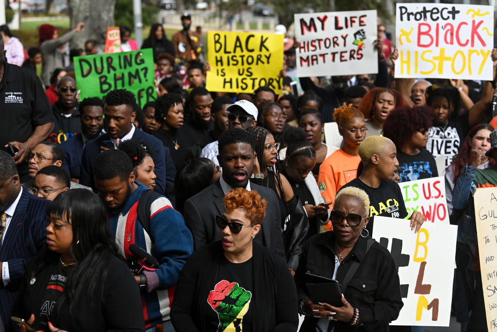 TALLAHASSEE, FL - FEBRUARY 15: Demonstrators protest Florida Governor Ron DeSantis plan to eliminate Advanced Placement courses on African American studies in high schools as they stand outside the Florida State Capitol on February 15, 2023 in Tallahassee, Florida. DeSantis says Advanced Placement courses on African American studies violates the Stop WOKE Act, which curbs race-related and gender curriculum from Florida classrooms. (Photo by Joshua Lott/The Washington Post via Getty Images)