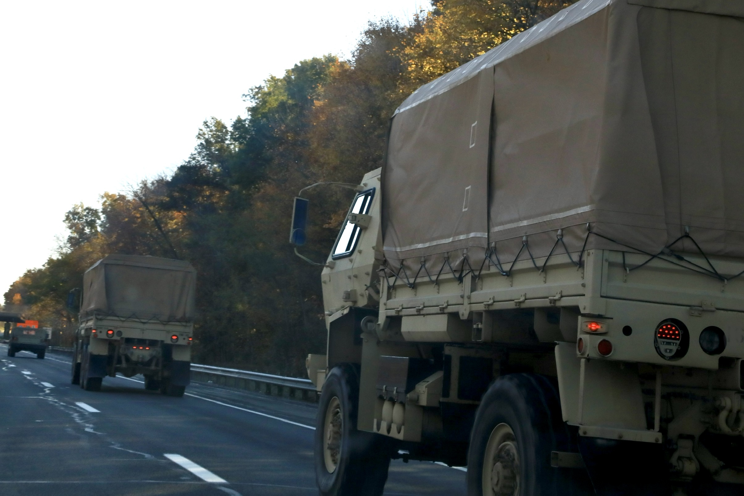 Military vehicle convoy on a highway