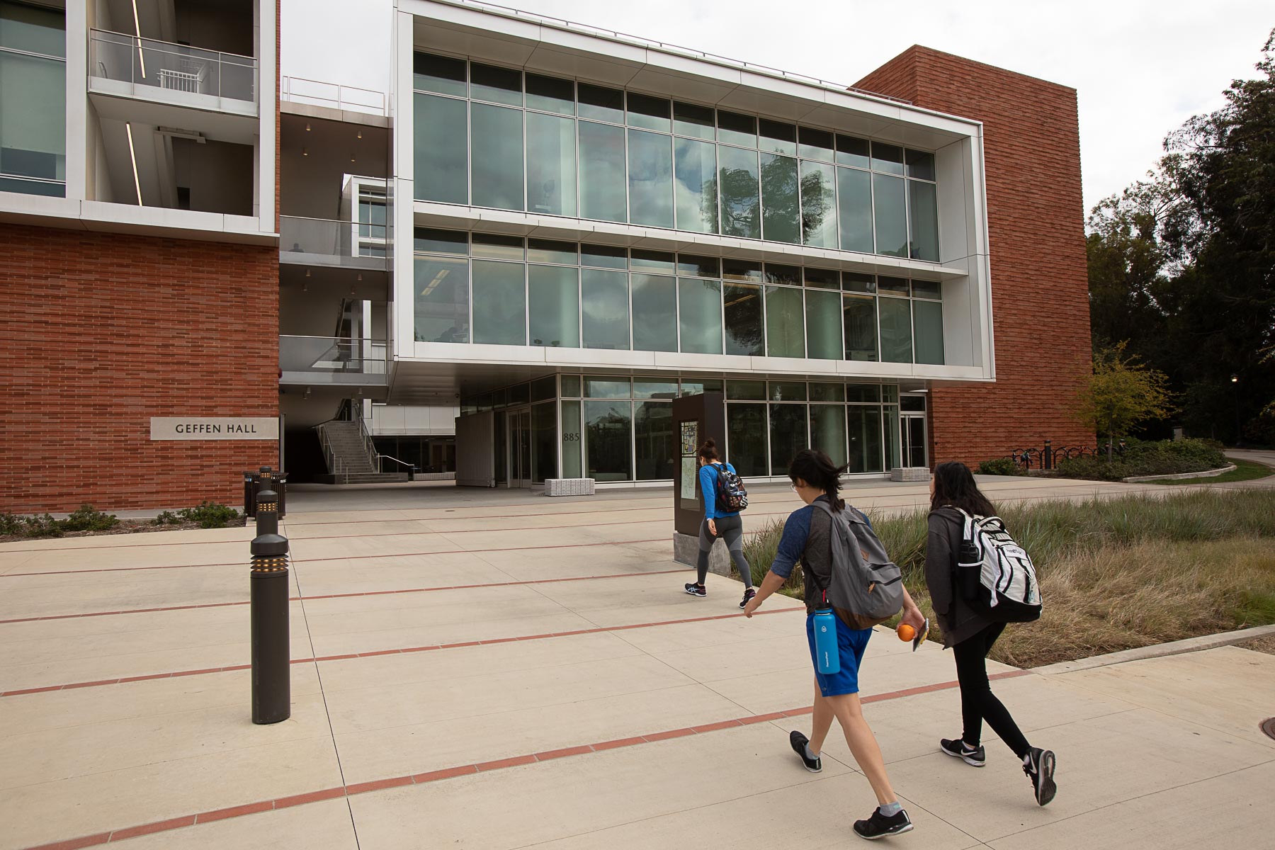 Two students walking toward Geffen Hall on UCLA's Campus.