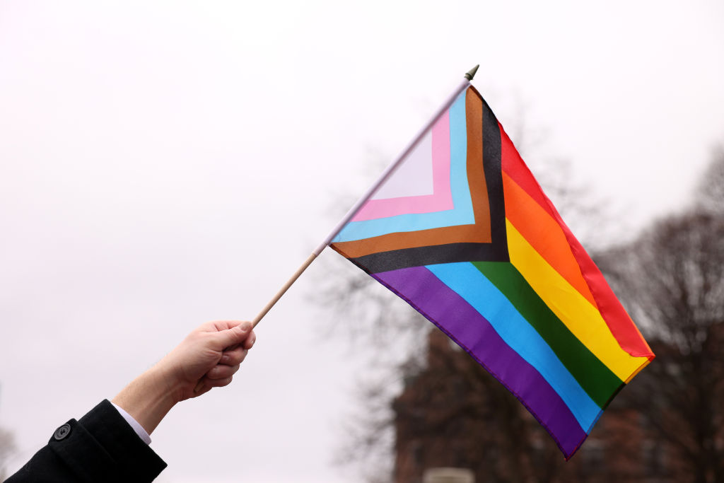 Boston, MA - March 31: A person waves a Pride flag during a Transgender Day of Visibility Event named, We Are A State of Love: A Gathering of Visible Solidarity With LGBTQ Youth outside of the State House in Boston on March 31, 2022. (Photo by Jessica Rinaldi/The Boston Globe via Getty Images)