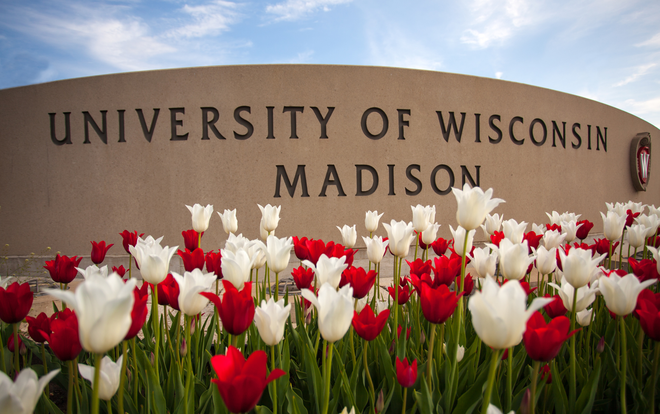 Madison, Wisconsin, USA - May 8, 2015: The University of Wisconsin crest and welcome sign is seen near the entrance to the UW Madison campus in Madison on May 8, 2015.