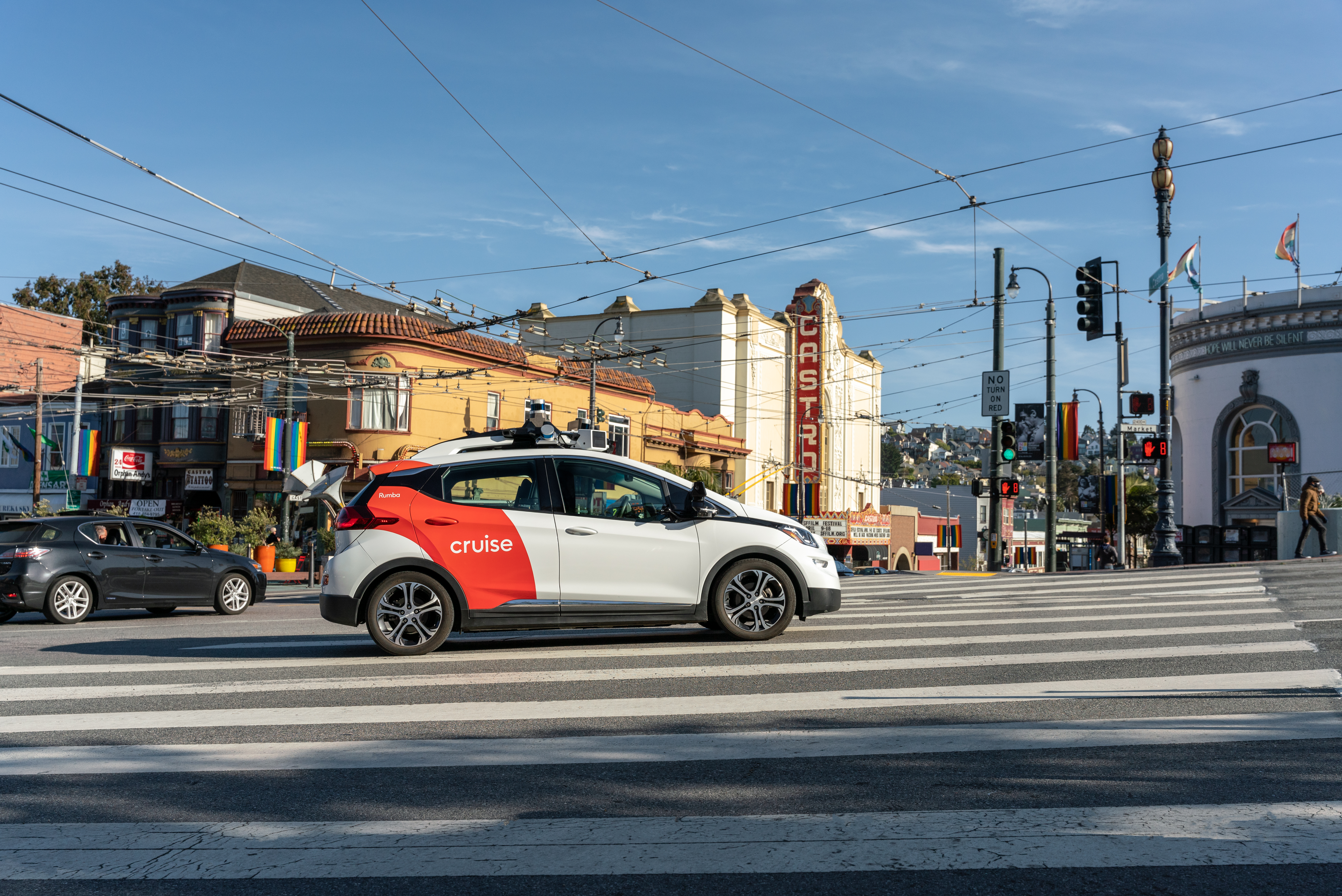 A Cruise autonomous vehicle driving down a busy street