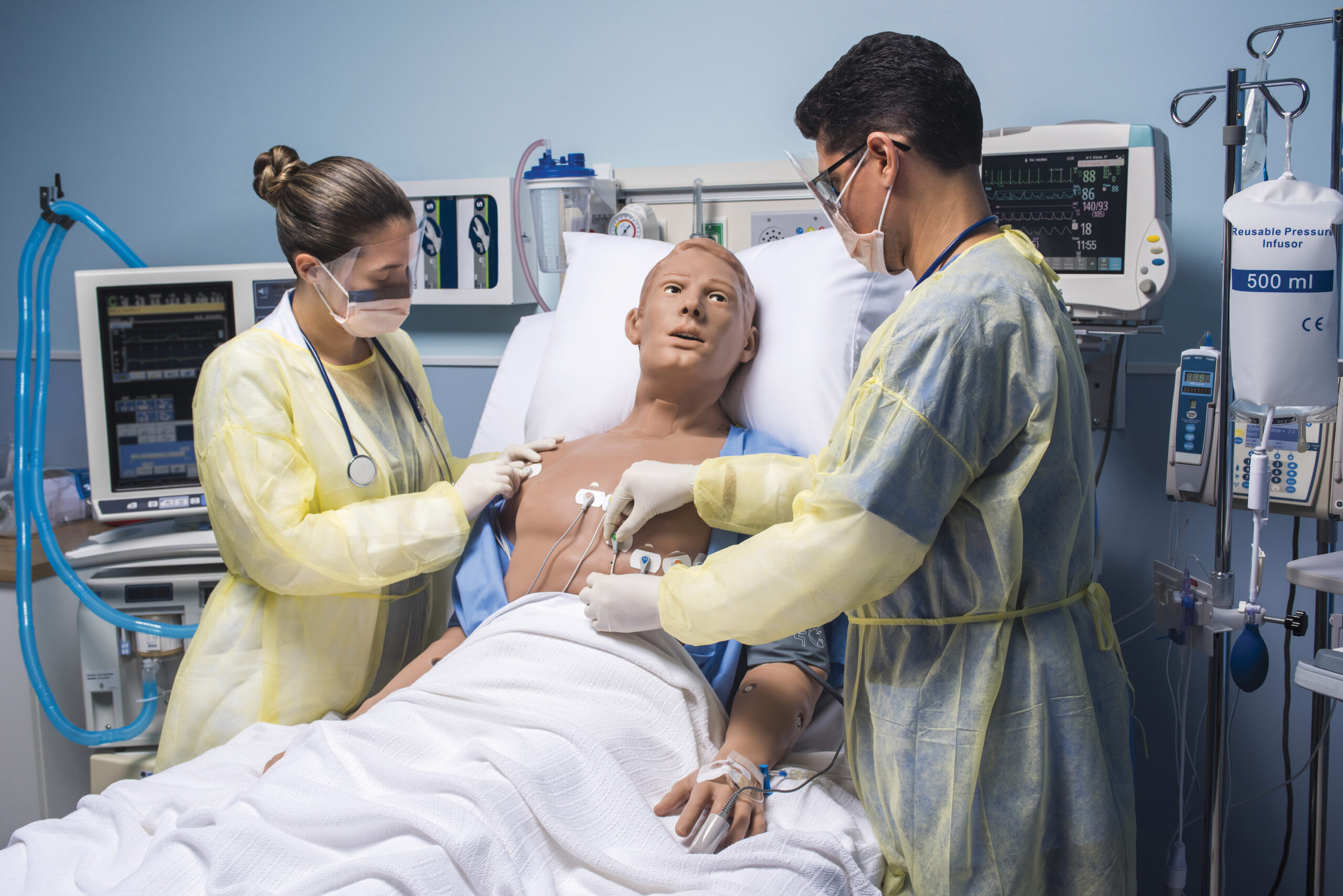 Nurses working on Emory HAL in a hospital bed