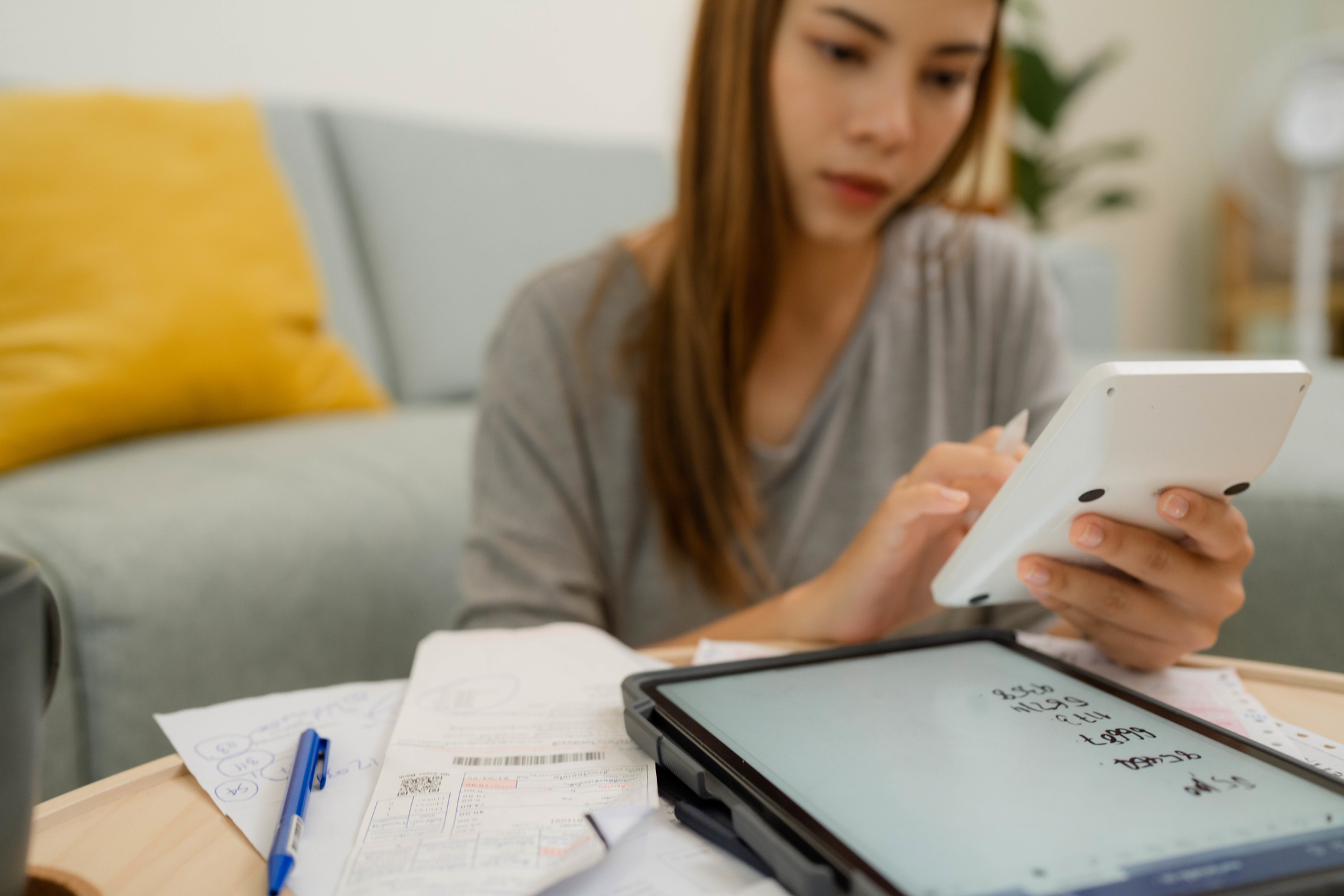 Woman analyzing documents while sitting at home.