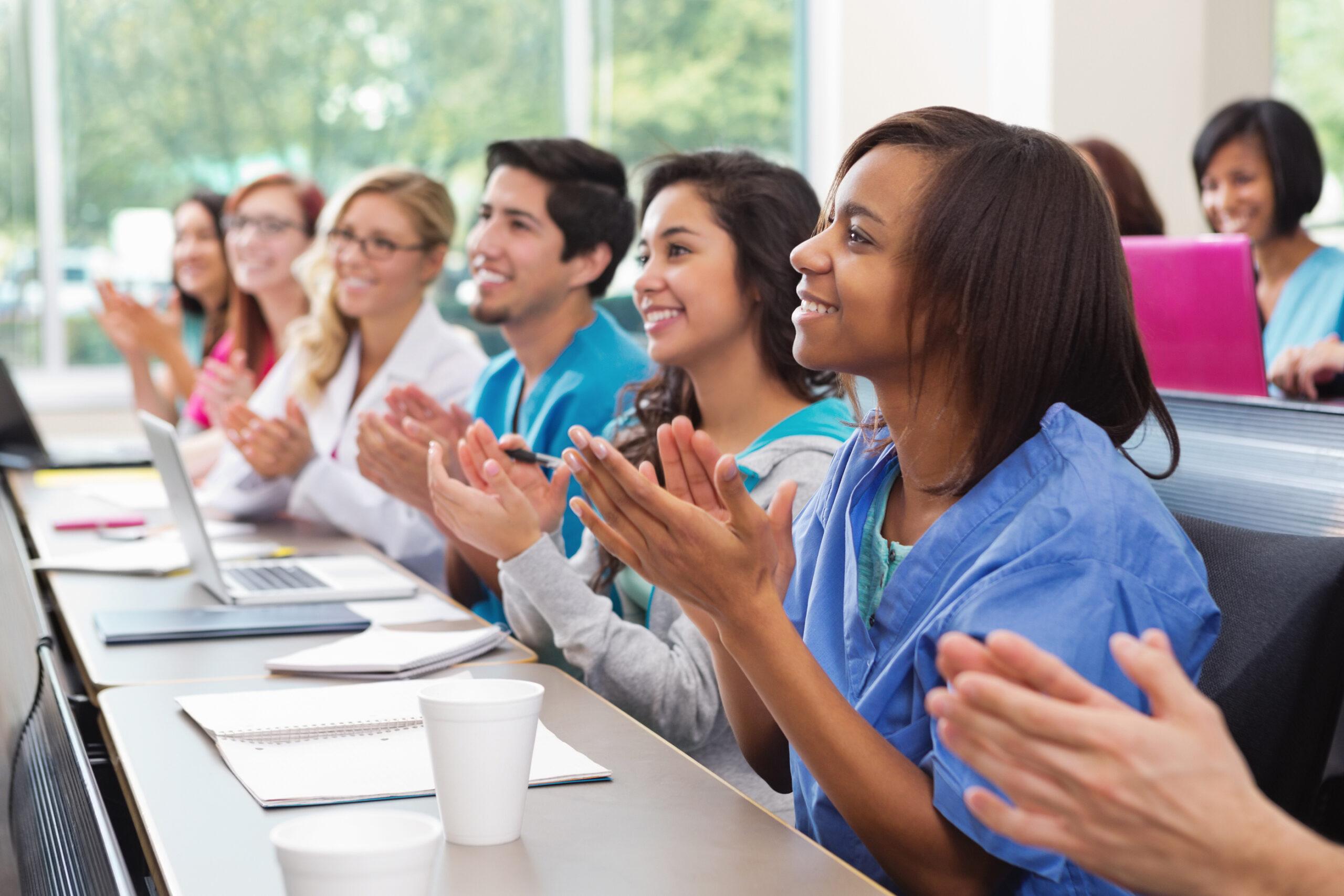 Nursing students clapping during a lecture